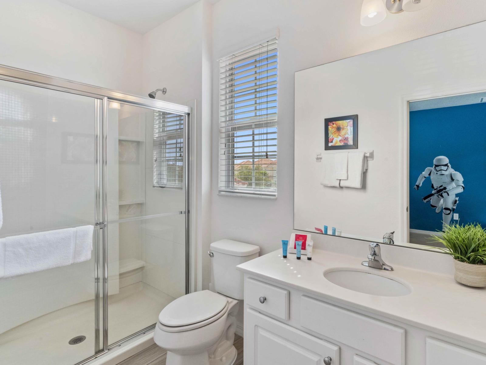 Enjoy a refreshing experience with the sleek walk-in shower in Bathroom 9.