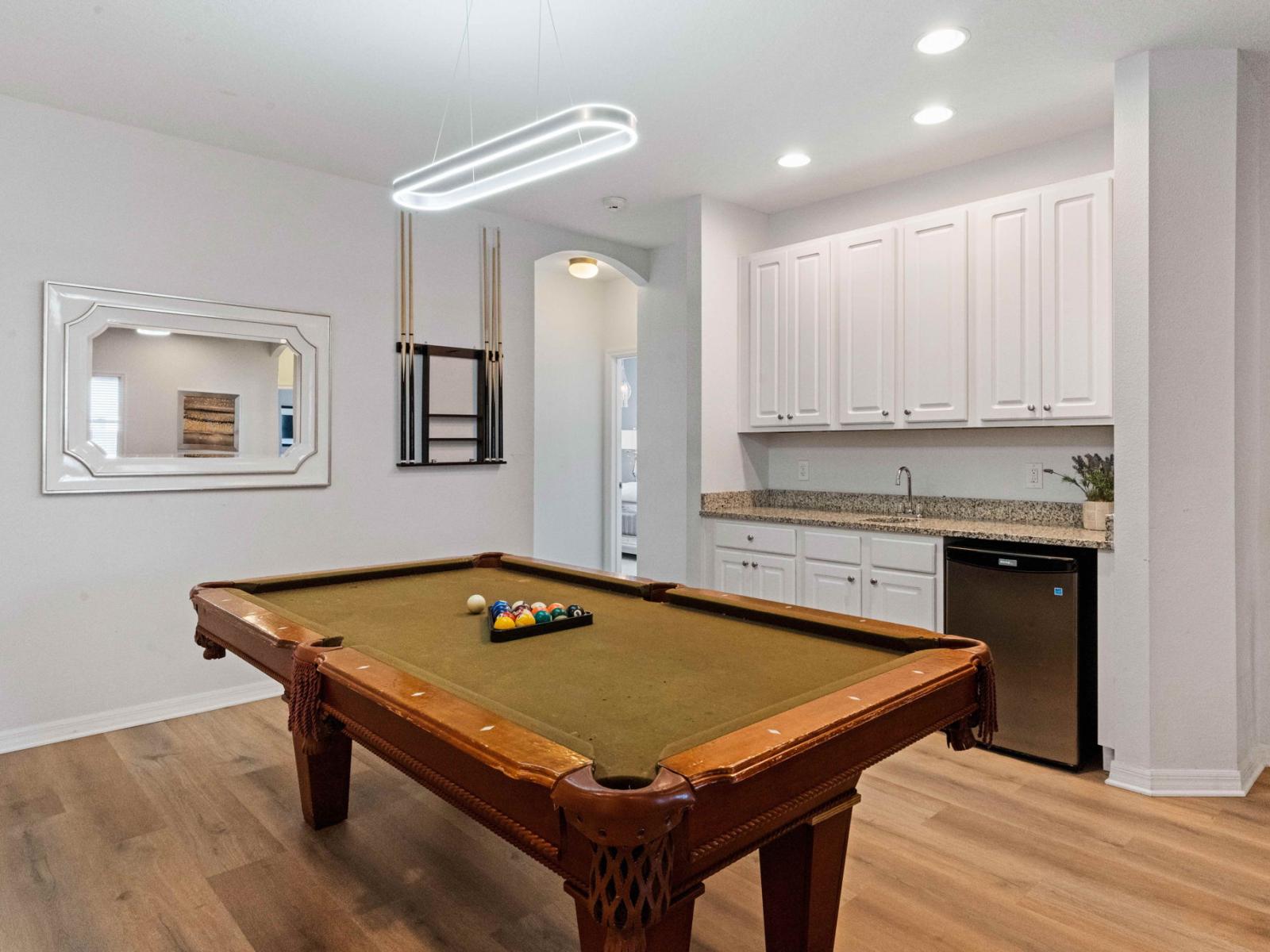 Game nights reach new heights in this stylish loft with a pool table centerpiece.