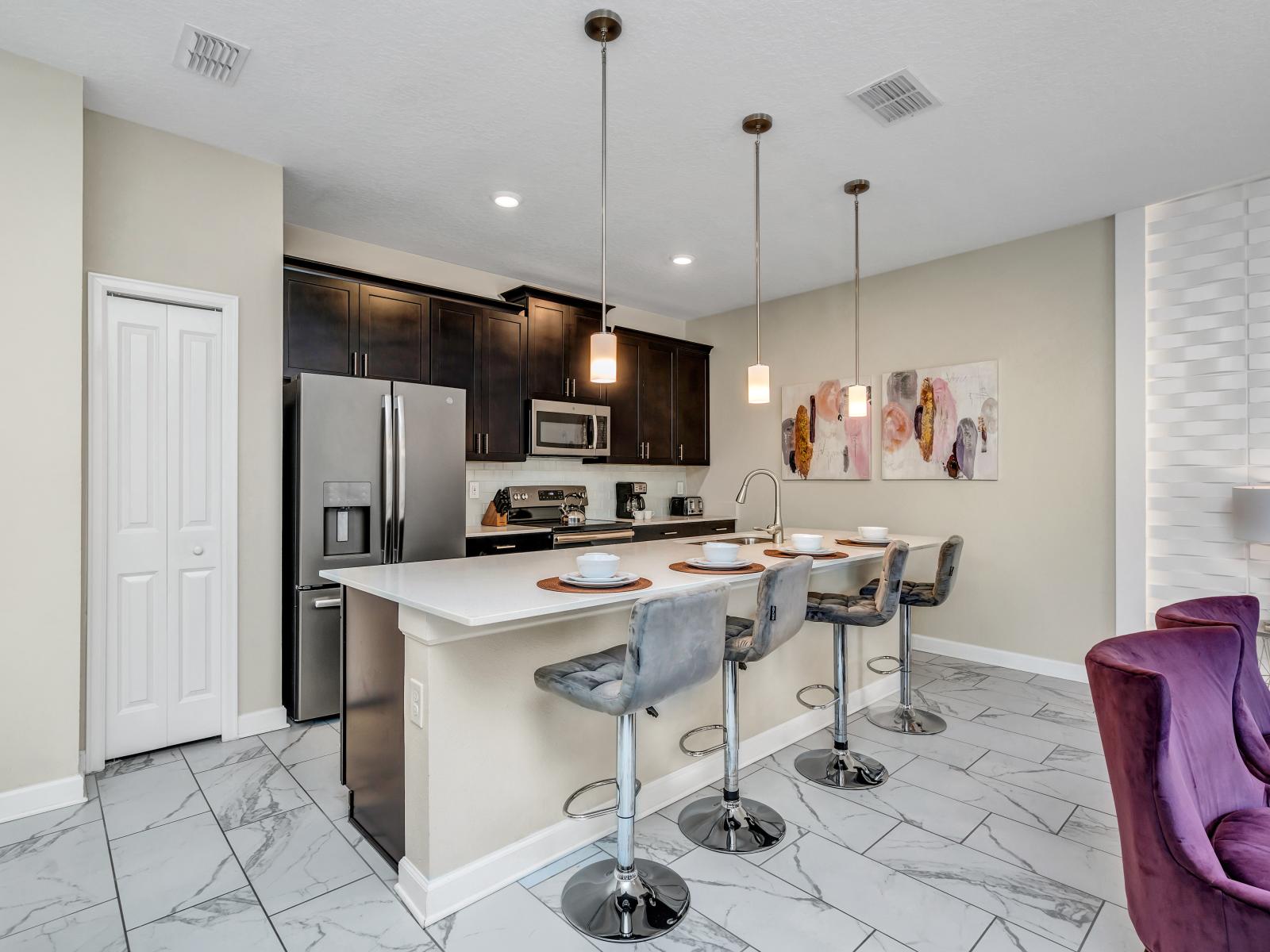 Modern Kitchen of the Townhouse in Kissimmee Florida - Contemporary design with clean lines and minimalist aesthetics - High Chairs and breakfast bar - Thoughtful placement of kitchen essentials for easy access