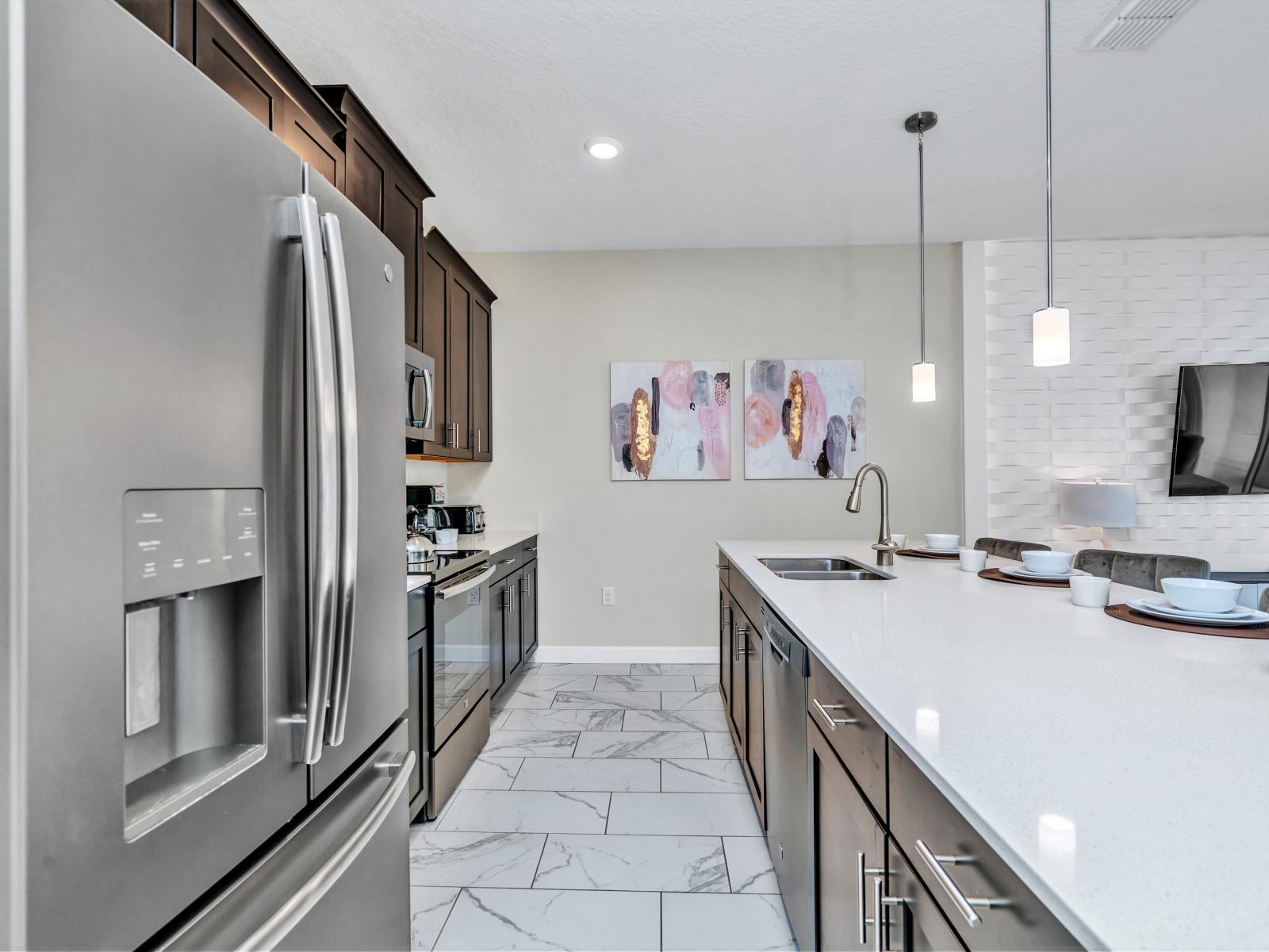 Sleek Kitchen of the Townhouse in Kissimmee Florida - Smart use of space with versatile storage solutions - Functional layout designed for efficient meal preparation - Stainless steel appliances