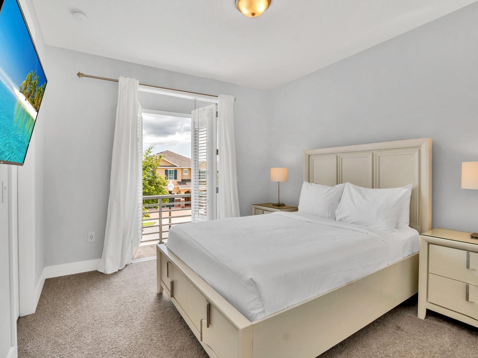 Resplendent Bedroom of the Apartment in Kissimmee Florida - King Size comfy bed - Plush bedding and pillows for a luxurious feel - Smart TV and Netflix - Spacious layout offering a sense of openness - Private Balcony