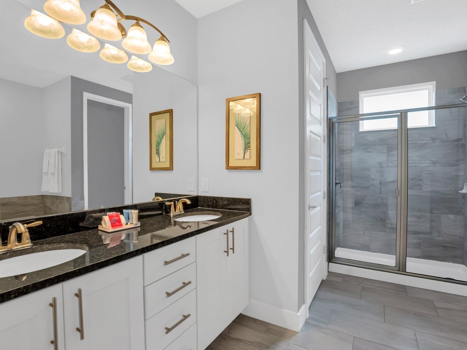 Lavish Bathroom of the Apartment in Kissimmee Florida - Contemporary fixtures for a touch of indulgence - Well-lit space with strategically placed mirrors for a spacious feel - n featuring a glass-enclosed shower for a modern touch