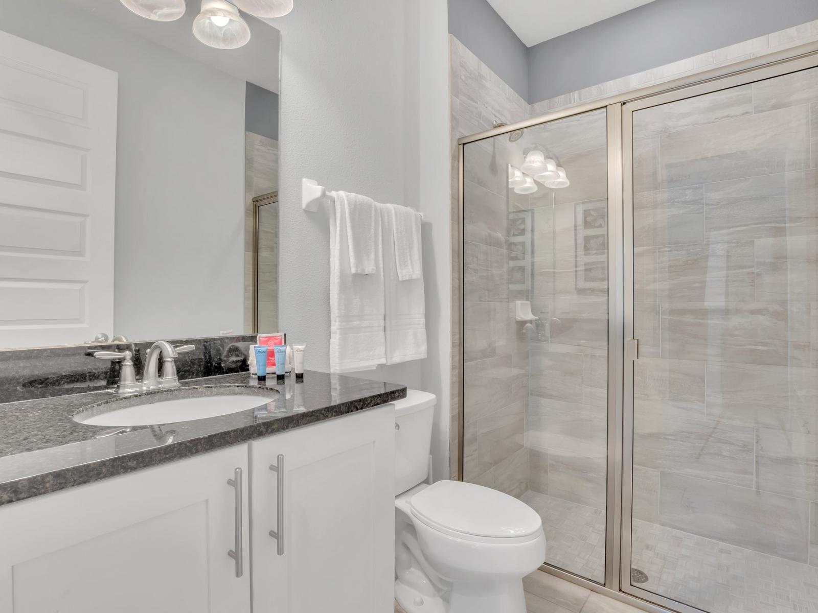 Invigorating Shower Space: Refresh and revitalize in our modern bathroom, boasting a spacious walk-in shower designed for your ultimate comfort.