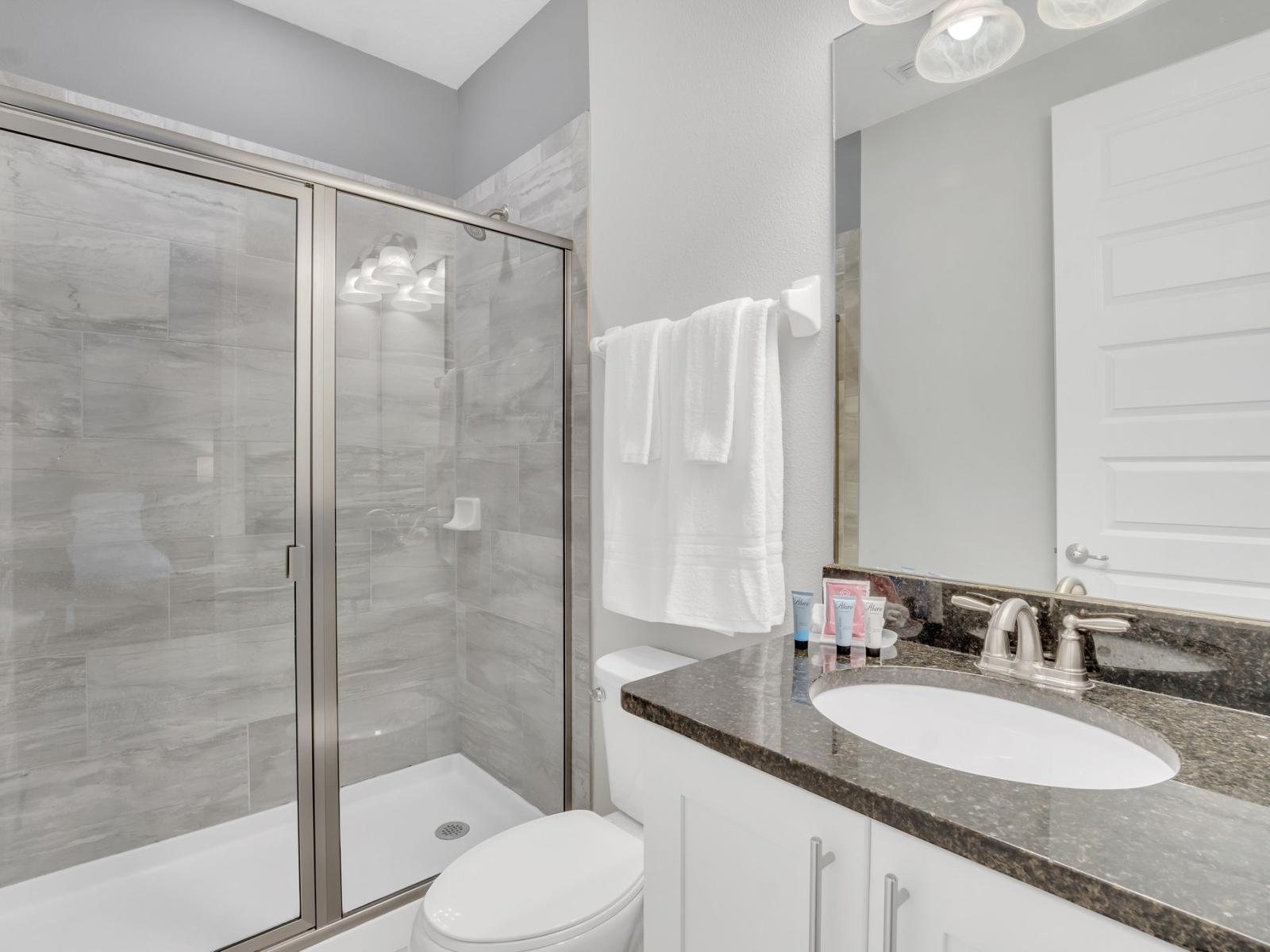 Invigorating Shower Space: Refresh and revitalize in our modern bathroom, boasting a spacious walk-in shower designed for your ultimate comfort.