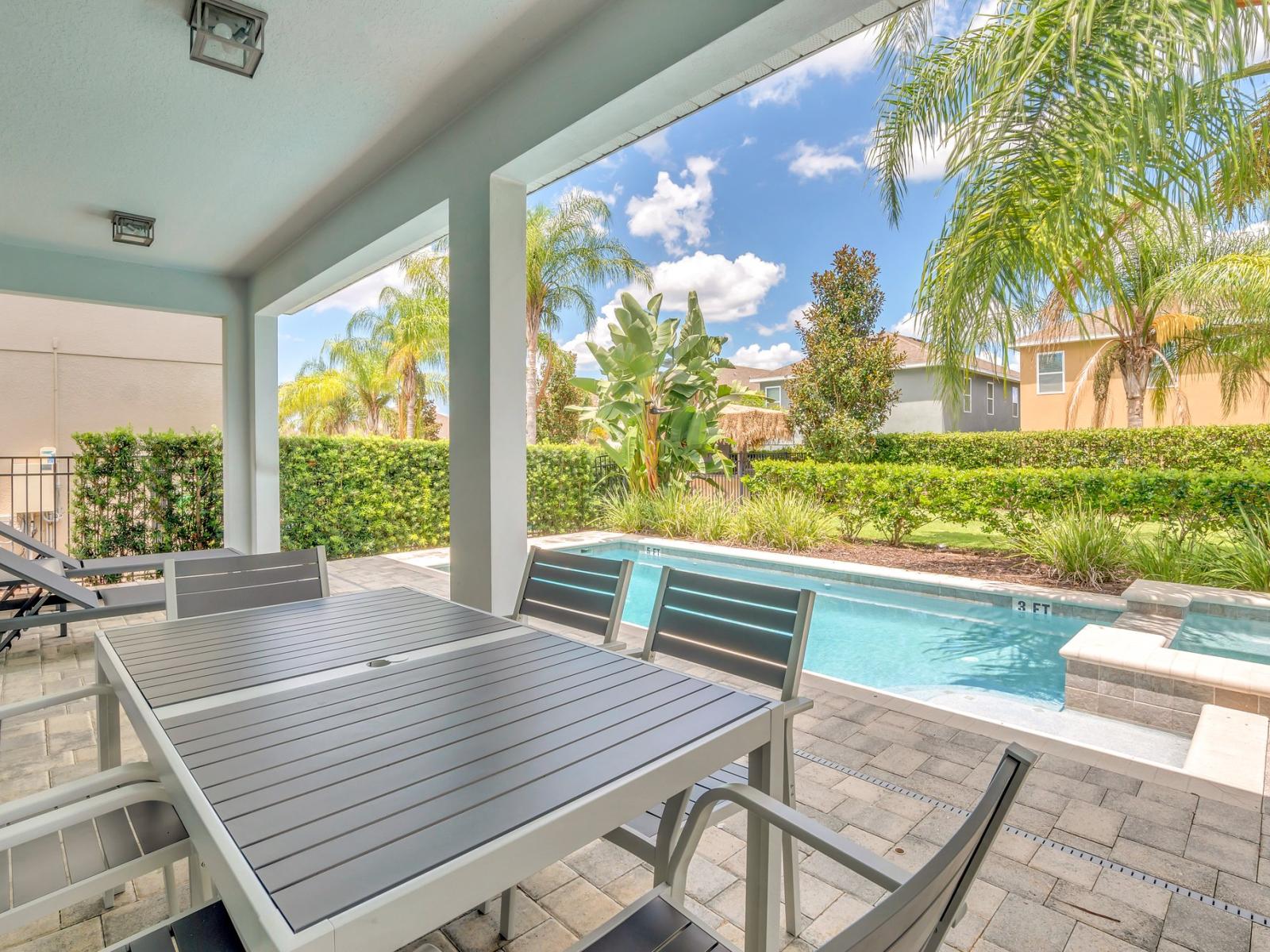 Refreshing Outdoor Sitting Area of the Apartment in Kissimmee Florida - Pleasing Atmosphere - Perfect for social gathering and relaxation - Covered with greenery like palm trees and tropical plants