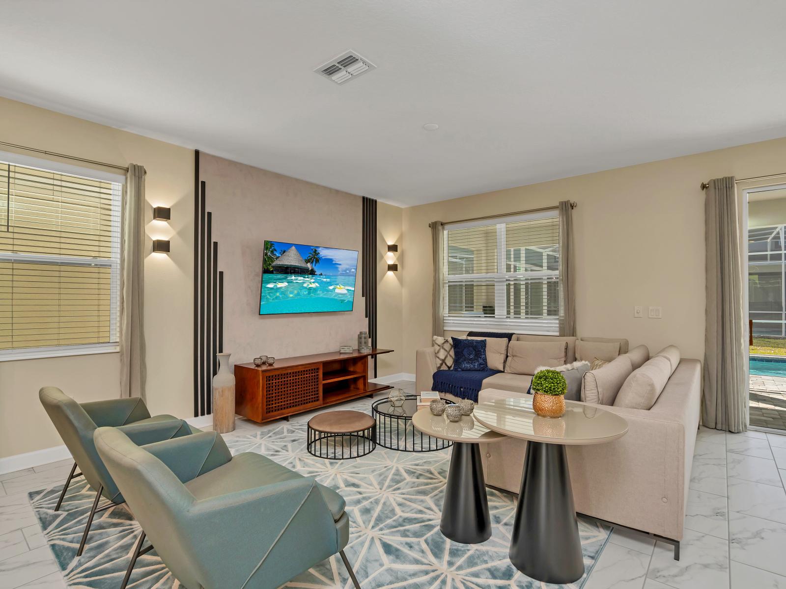 Modern and spacious living room adorned with elegant furnishings and a large Smart TV, creating the perfect setting for relaxation and entertainment.