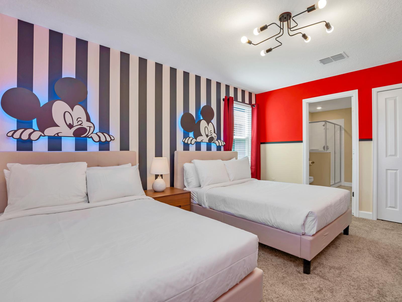 Featuring his classic color palate, two character icon wall displays, and a pair of queen size beds, this cute bedroom is a magical kingdom unto itself.