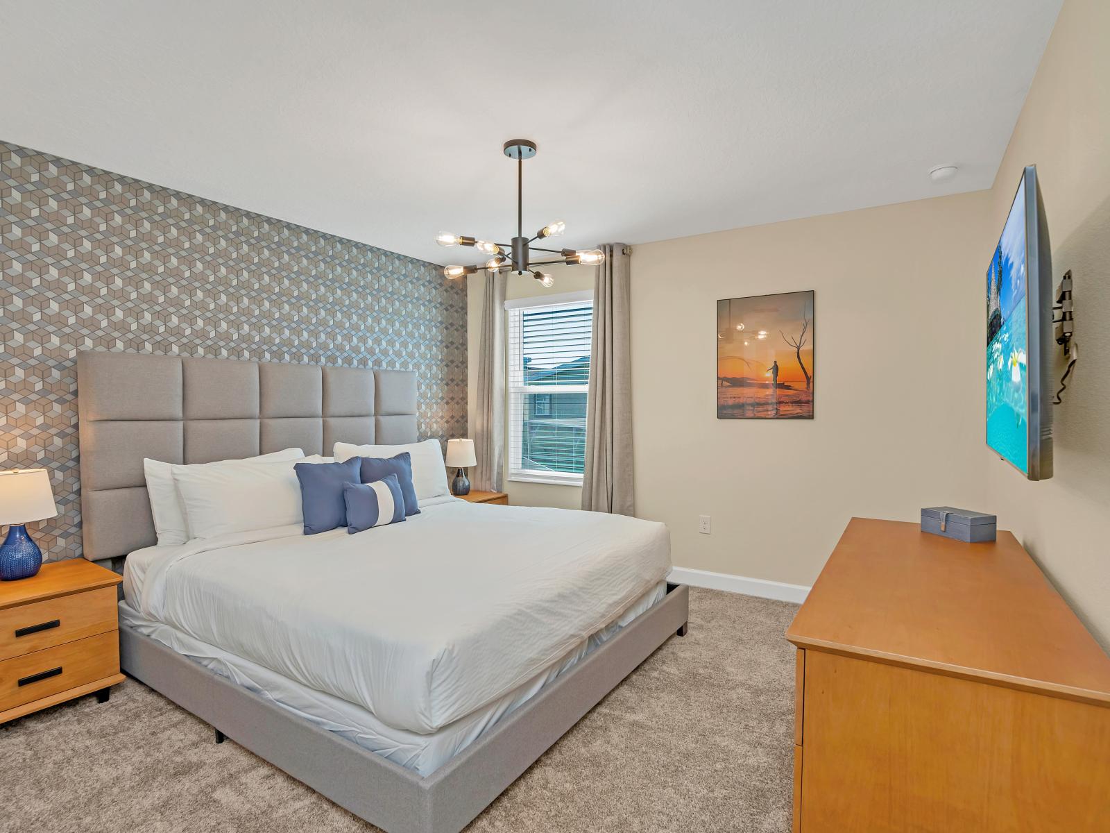 A massive king size bed, double-wide dresser, mesmerizing geometric accent wall, and two-door closet gives this dwelling ample room to shine!