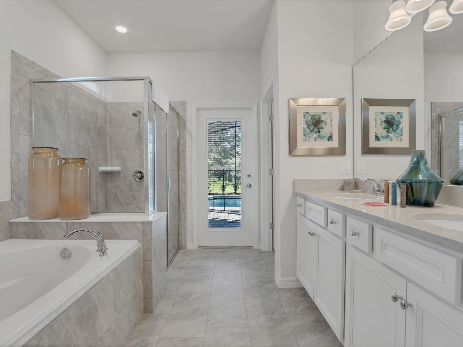 Deluxe Bathroom of the Apartment in Davenport Florida - Chic design featuring a sleek vanity and upscale lighting - Seamless design featuring a glass-enclosed shower - Separate Bathtub - Spacious layout offering a sense of luxury and comfort