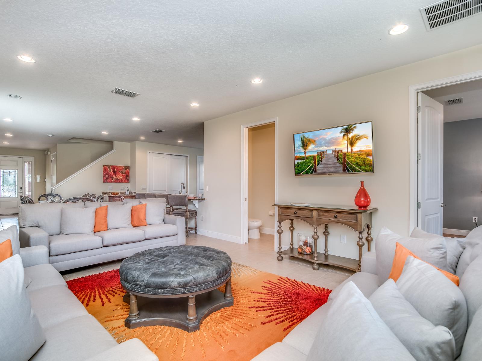 Chic Living Area of the Home in Kissimmee Florida - Smart TV and Netflix - Lighting floods the room, enhancing its warmth and inviting atmosphere - Cozy seating area conducive to relaxation and socializing