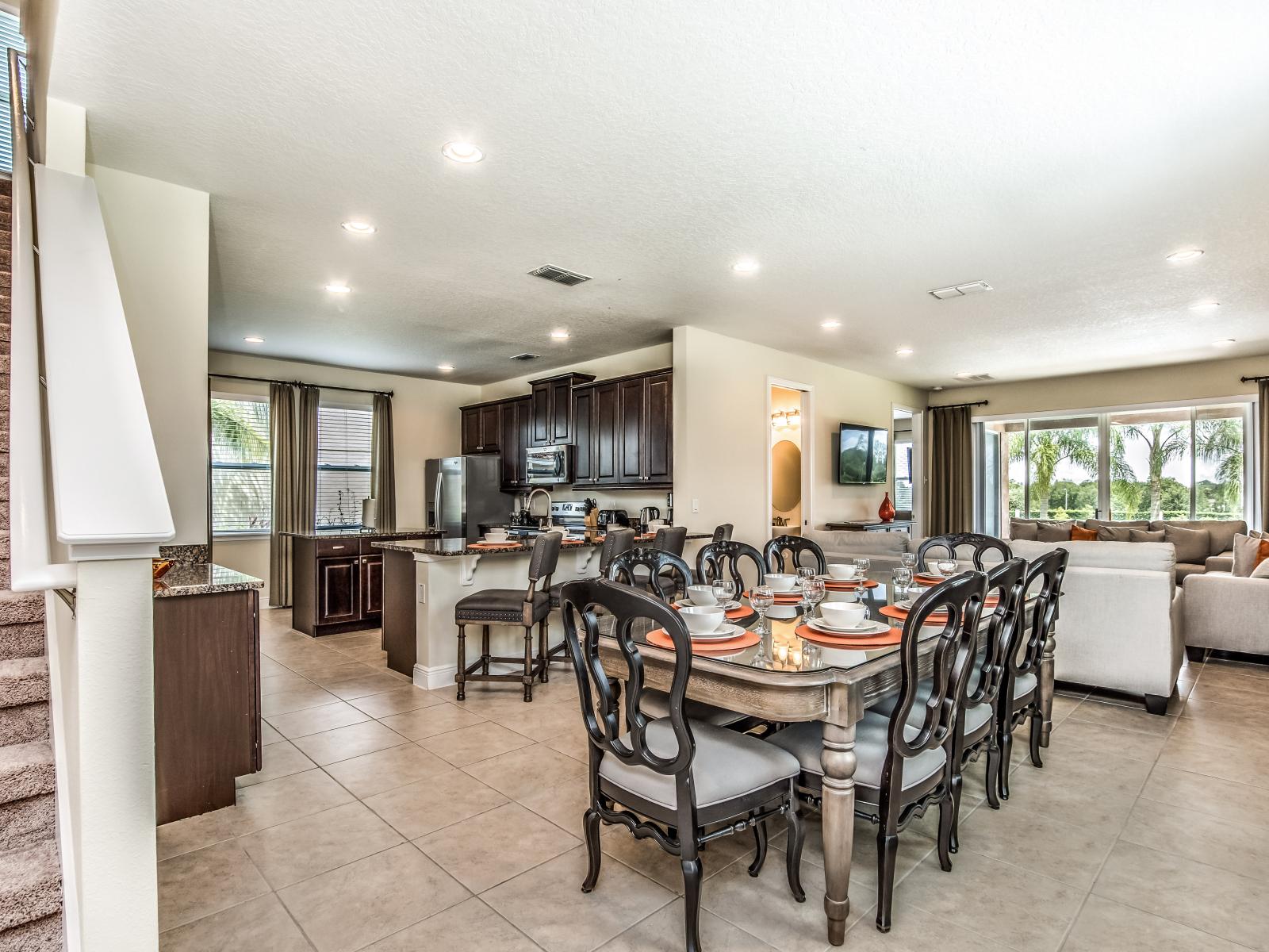 Stunning Home in Kissimmee Florida - Open layout seamlessly connecting the dining area to the kitchen and living area - Stylish, contemporary furnishings enhancing the aesthetic - Plush and comfortable seating arrangements