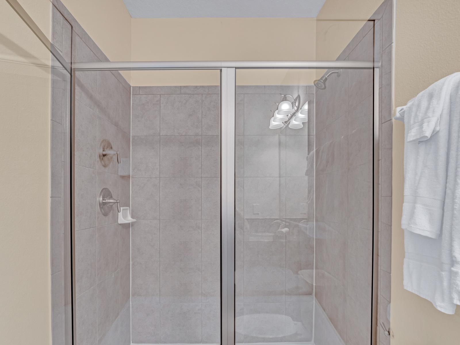 Clean Bathroom of the Home in Kissimmee Florida - Glass-enclosed walk-in shower area - Elegant bathroom with luxurious fixtures and finishes