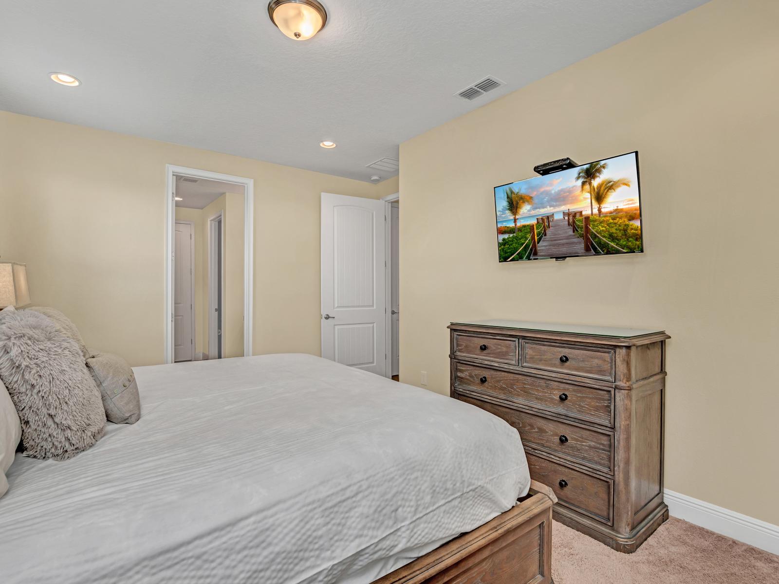 Luxe Bedroom of the Home in Kissimmee Florida - Cozy textiles and plush bedding for a restful night's sleep - Smart TV and Netflix - A tranquil ambiance perfect for unwinding and rejuvenating