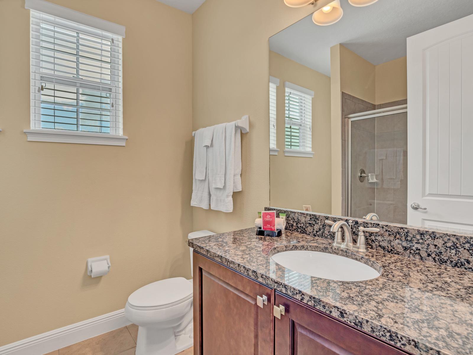 Polished Bathroom  of the Home in Kissimmee Florida - Elegantly designed - Chic dual vanity with large mirror - Elegant bathroom with luxurious fixtures and finishes