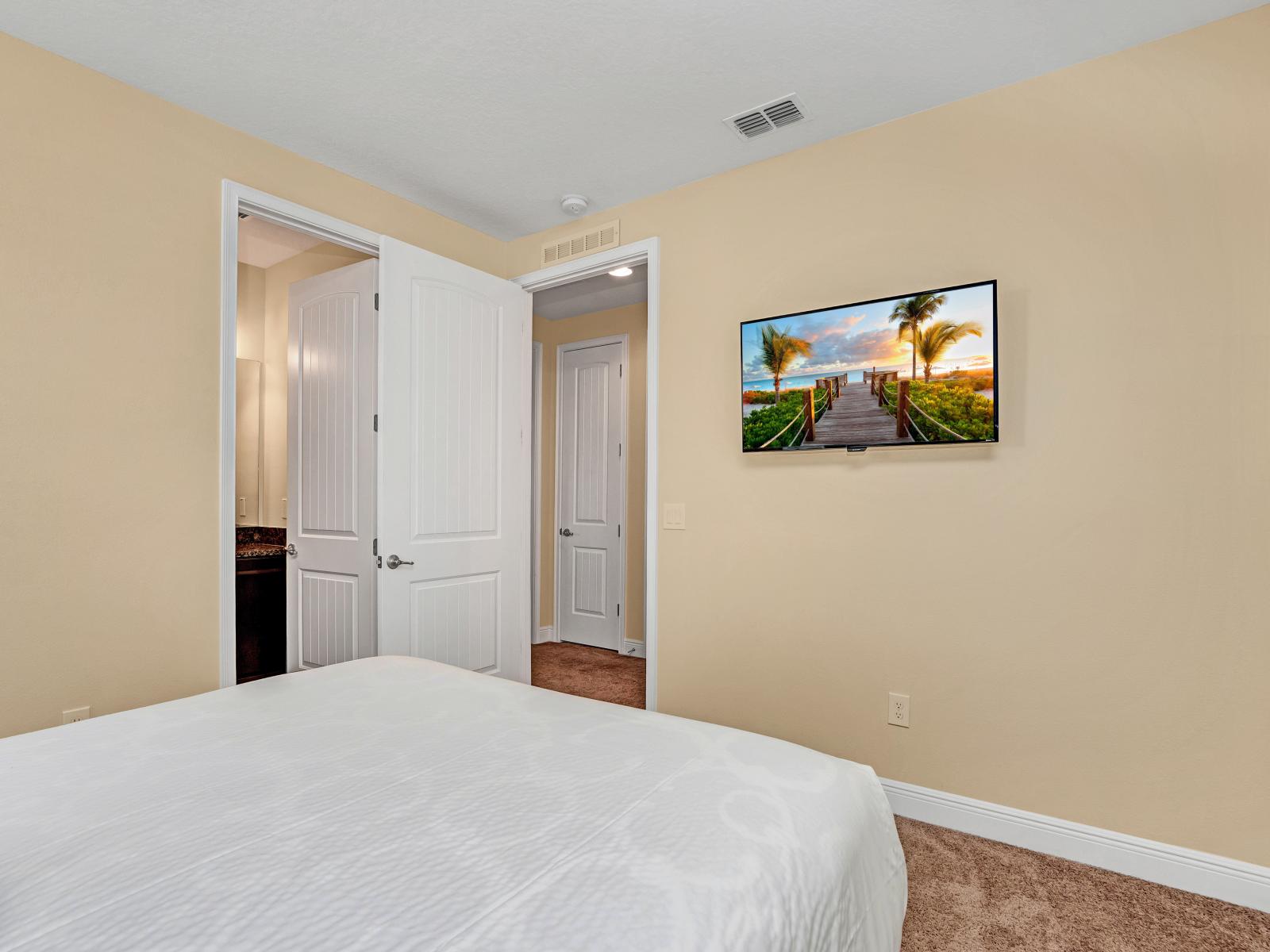 Exclusive Bedroom of the Home in Kissimmee Florida - Smart TV and Netflix - Soft lighting and natural textures creating a cozy vibe - Cozy retreat with a plush bed, perfect for relaxation