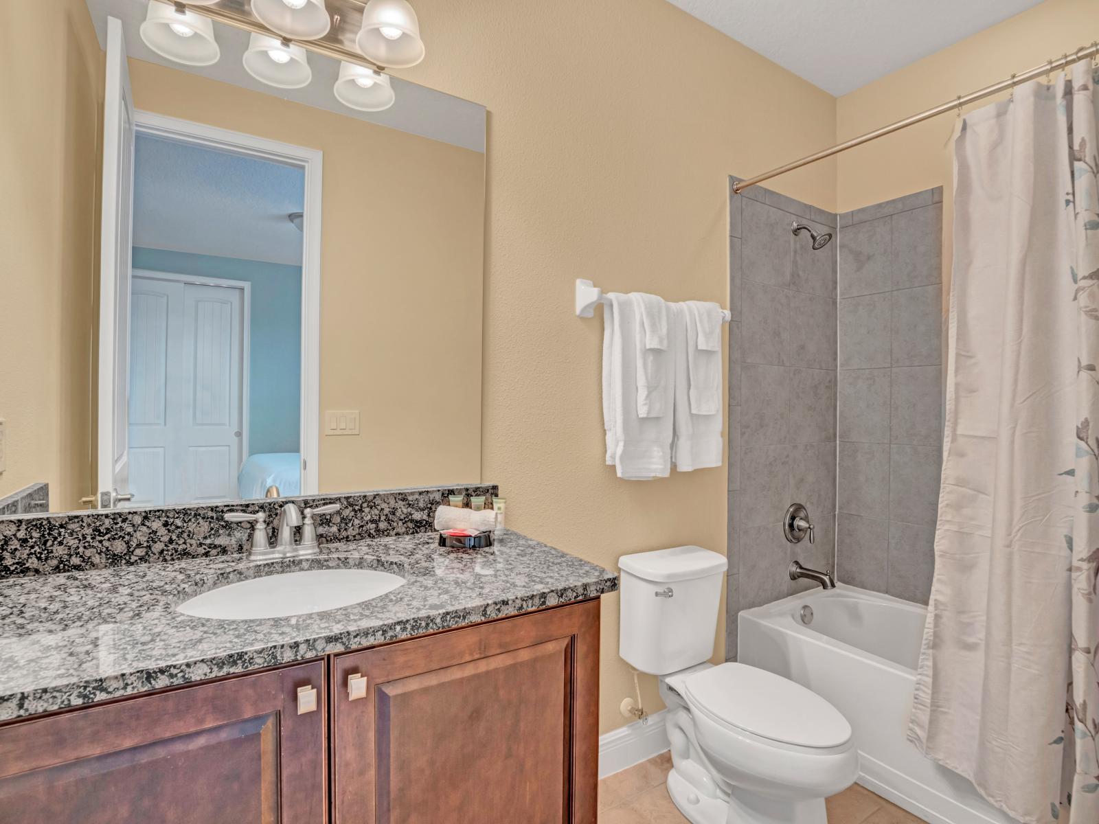 Elegant Bathroom of the Home in Kissimmee Florida - Sophisticated color palette creating a serene ambiance - Attention to detail, from the elegant tiles to the faucets