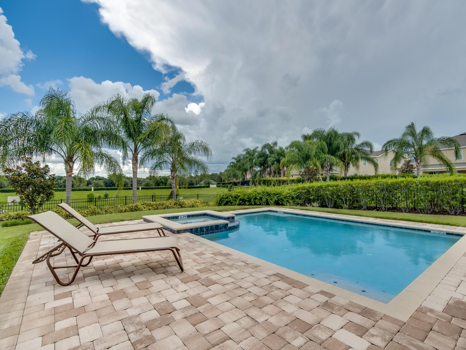 Stunning Outdoor Pool Area of the Home in Kissimmee Florida - Sun-kissed vibes, refreshing waters, and comfortable lounges - Converge to create the perfect oasis for relaxation and enjoyment - Immerse yourself in the ultimate poolside retreat