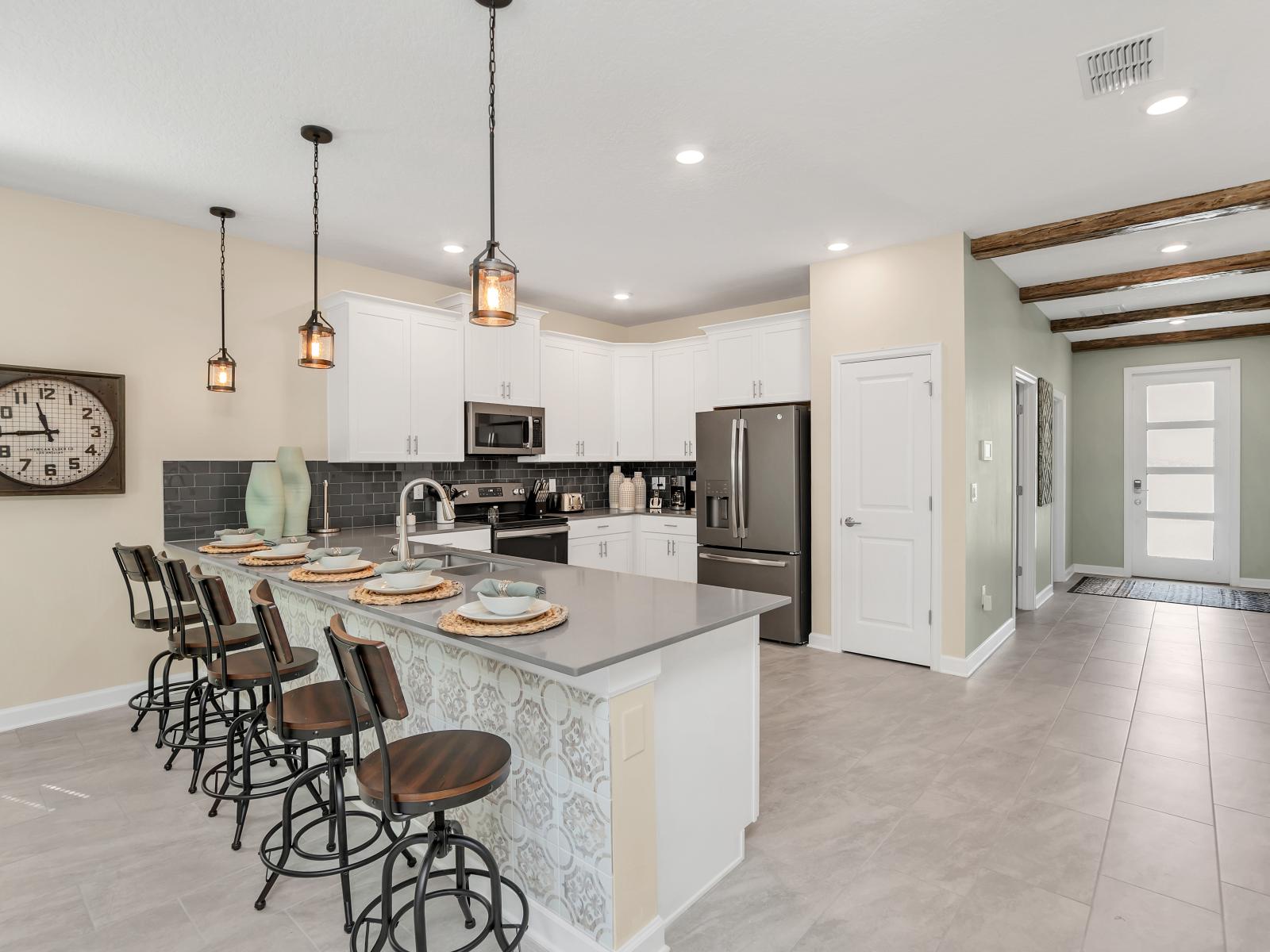 Spacious Kitchen of the Home in Reunion Florida - Integrated appliances for a seamless and stylish appearance - Thoughtful placement of kitchen essentials for easy access - Coordinated kitchen decor for a polished and inviting atmosphere