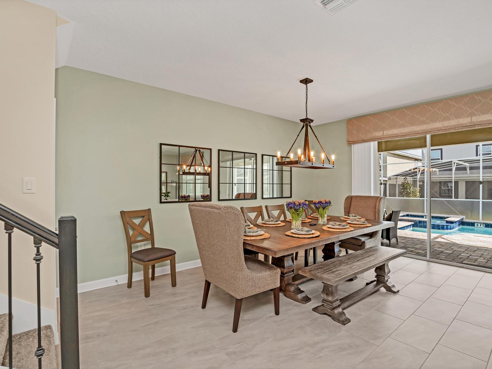 Luxe Dining Area of the Home in Reunion Florida - The inviting dining room for memorable meals and cherished moments - 8 Persons Dining - Strategic use of mirrors to enhance the perception of space - Chic dining area with a statement chandelier