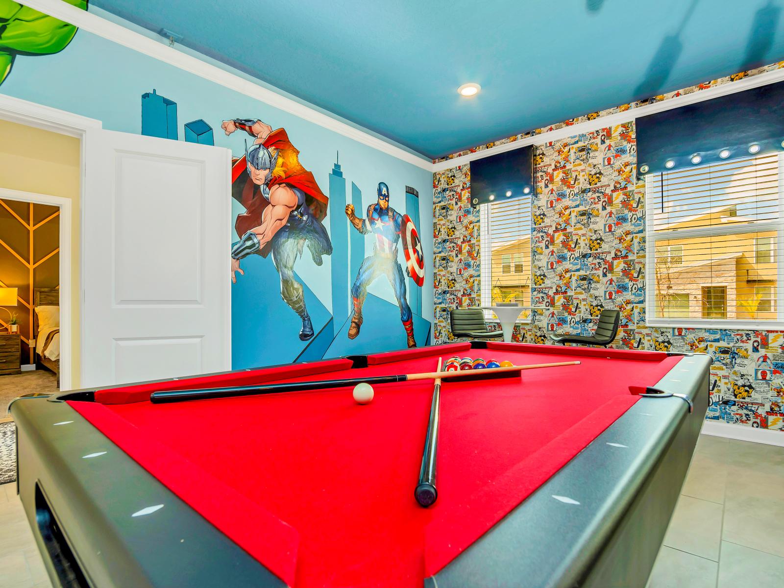 Pool Table of the Home in Reunion Florida - The game room boasts a captivating Marvels theme - Offering guests an immersive and thrilling experience