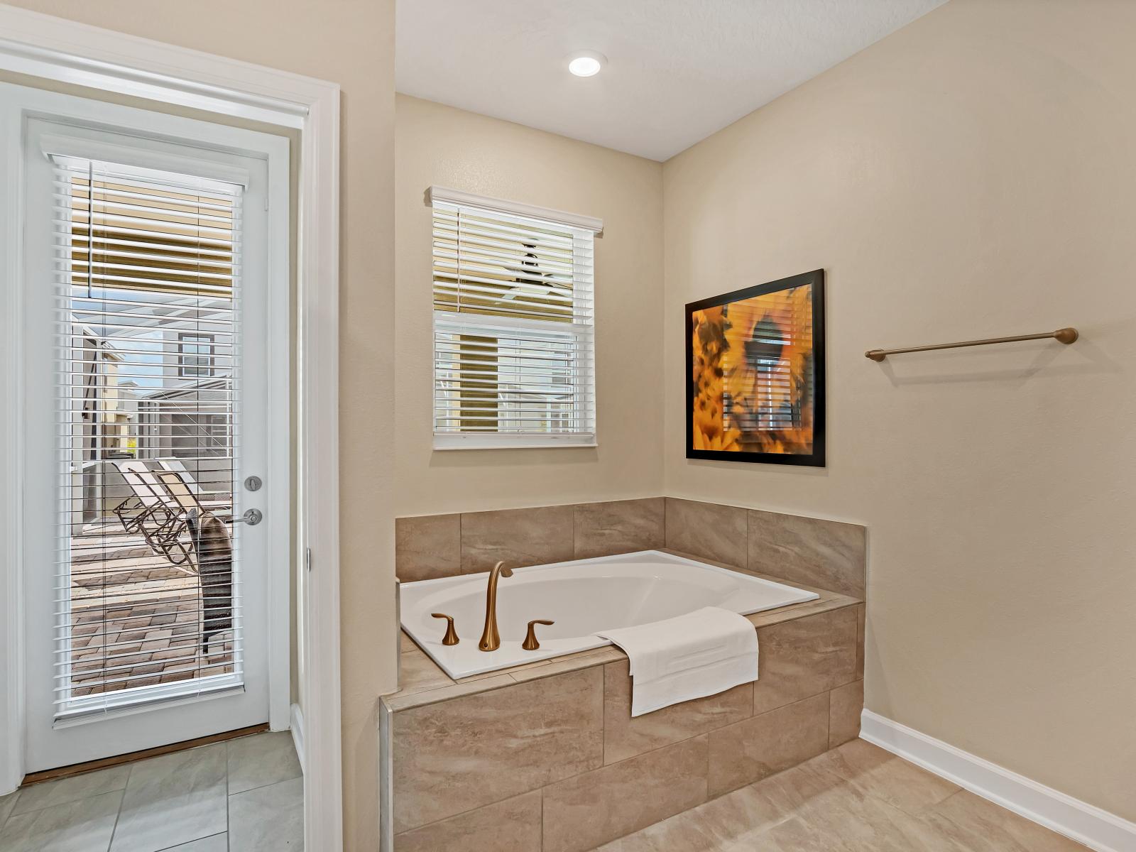 Luxury Bathroom of the Home in Reunion Florida - The bathtub is a luxurious retreat where you can unwind - Inviting bathroom with a soothing color palette for a tranquil feel