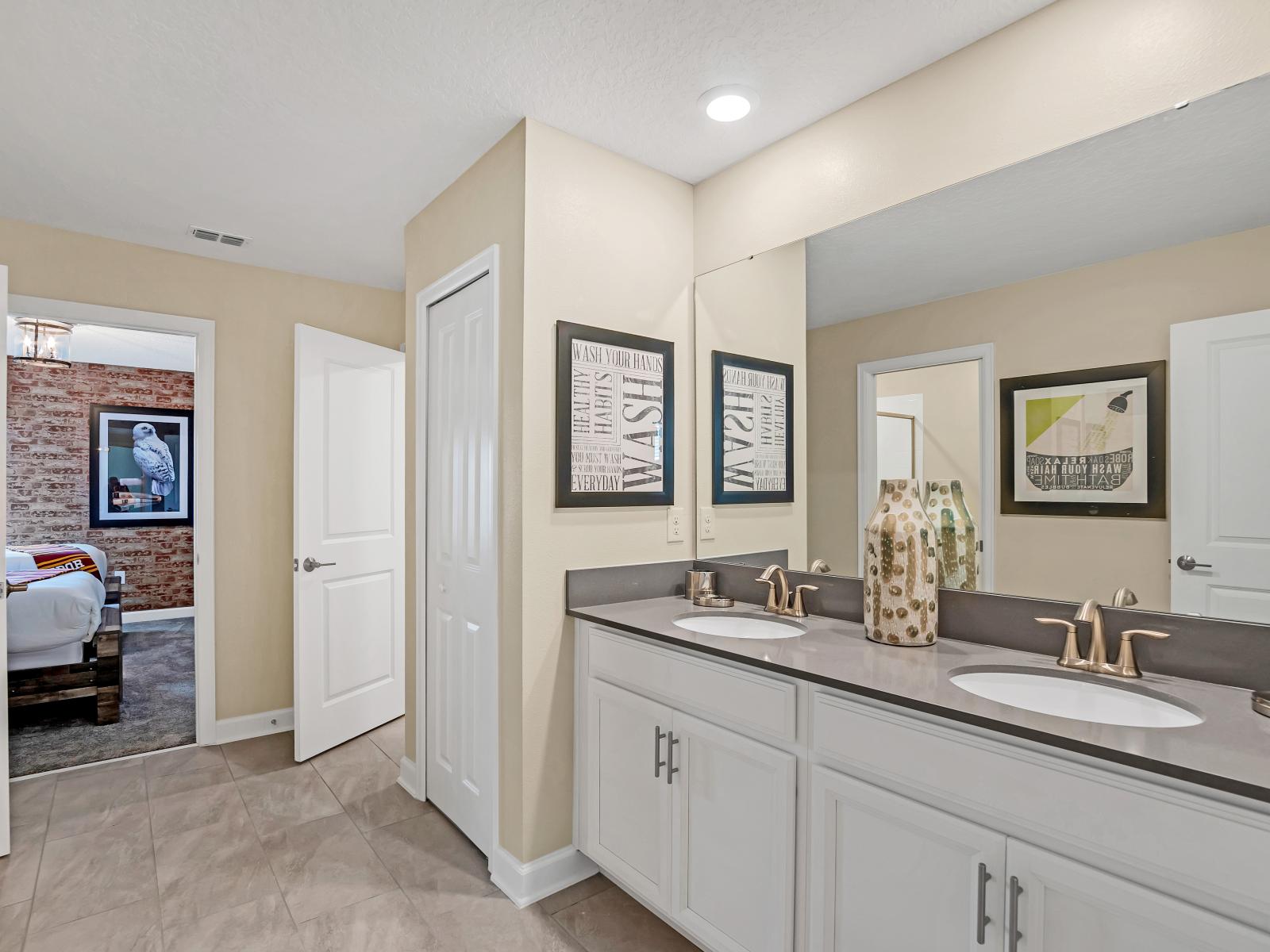 Polished Bathroom of the Home in Reunion Florida - Experience the convenience of comfort in ensuite bathroom - Offering a relaxing and well-equipped space - Lush Dual Vanity with large mirror