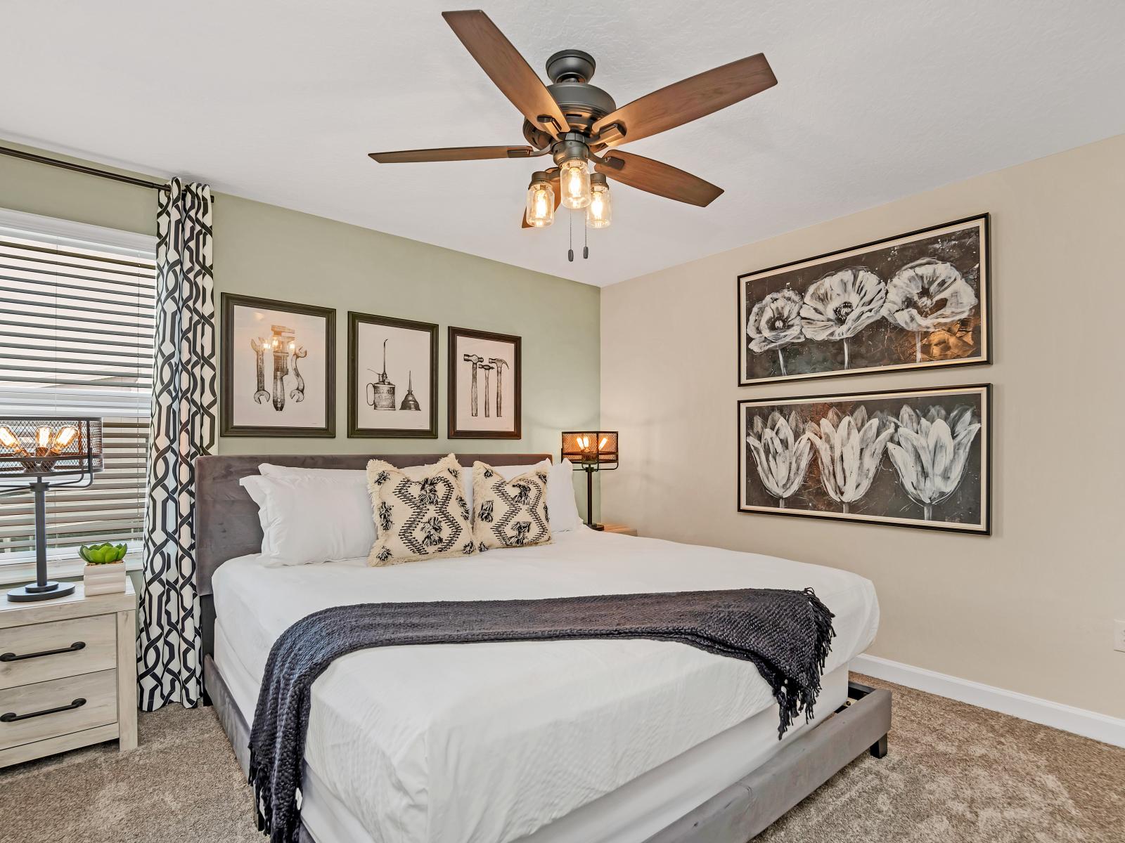 Chic bedroom of the Home in Reunion Florida - Offers a stylish and tranquil retreat for rest and relaxation with comfy bed - Elegant decor and wall work - Well-appointed bedroom with neutral tones for a calming atmosphere