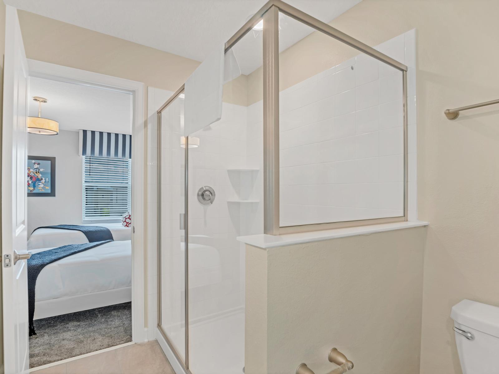 The shower enclosure epitomizes modern design and comfort. With sleek fixtures and a spacious layout, it offers guests an inviting space to refresh and rejuvenate.