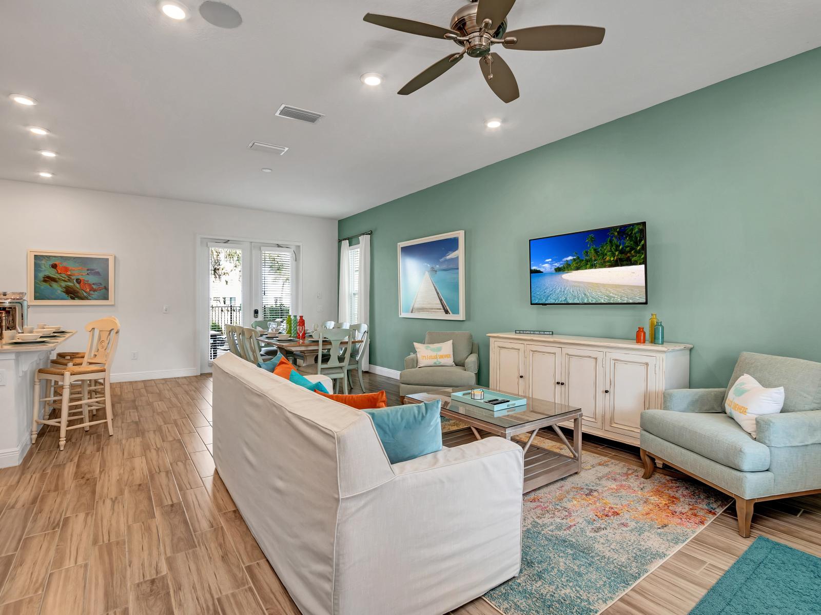 Glamorous living area of the cottage in Kissimmee Florida - Cozy sofas  - Seamless connection to dining space - Smart TV and Netflix - Harmonious color scheme with pops of accent colors for visual interest