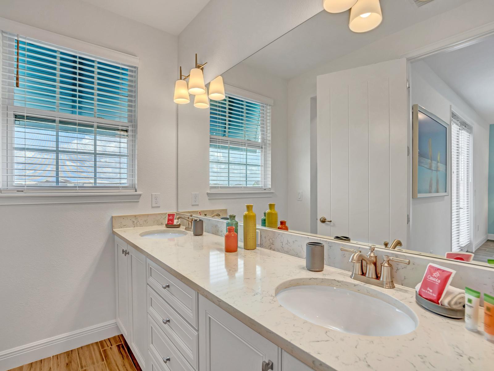 Refreshing bathroom of the cottage in Kissimmee Florida - Vanity area offers basic essentials for your comfort and convenience - Elevating your stay with simple luxury - Lush dual vanity with large mirror and upscale lighting