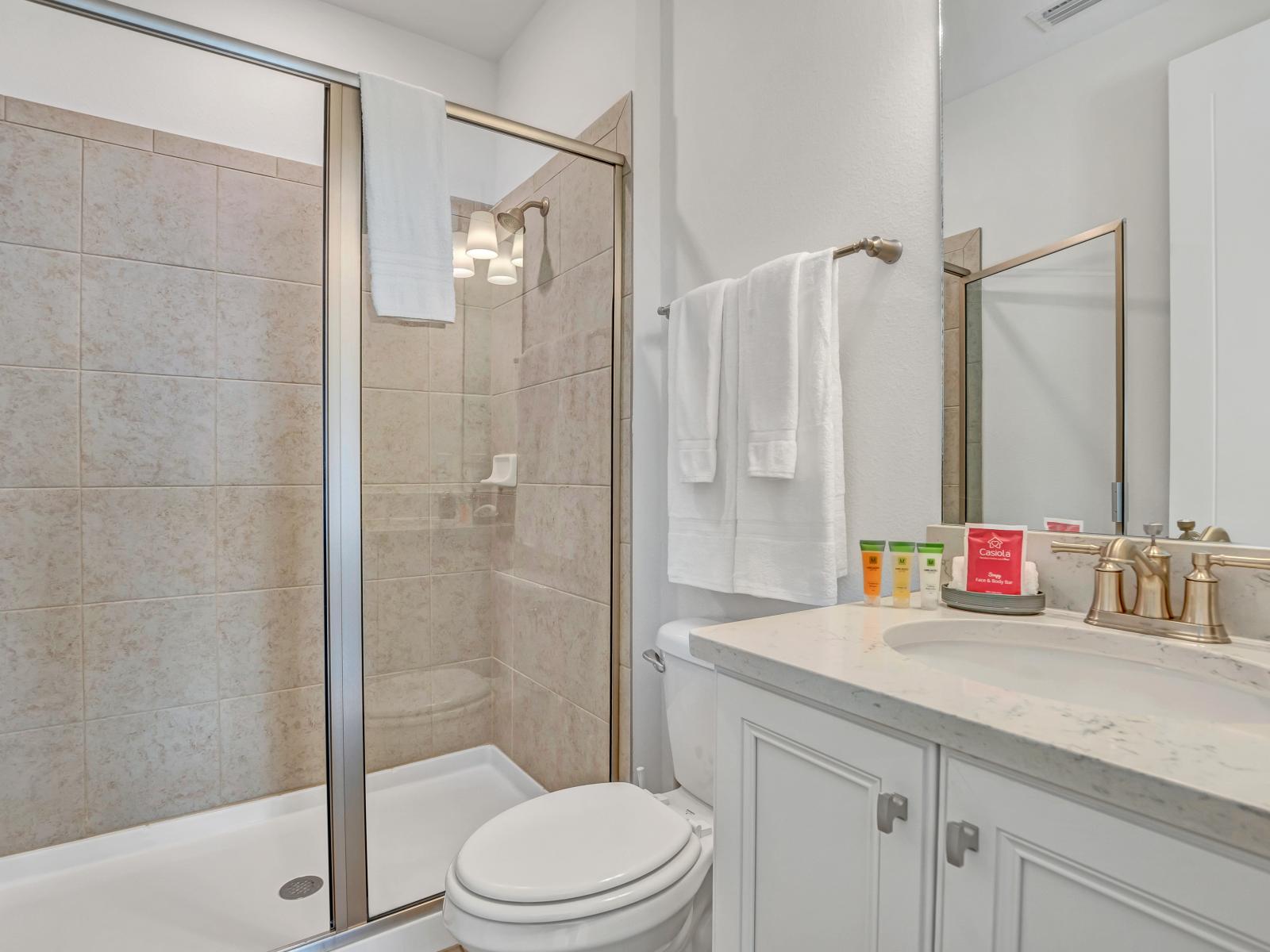 Contemporary Comfort: Enjoy contemporary comfort in our bathroom, equipped with a vanity mirror, dual sinks, and a luxurious walk-in shower for your convenience.