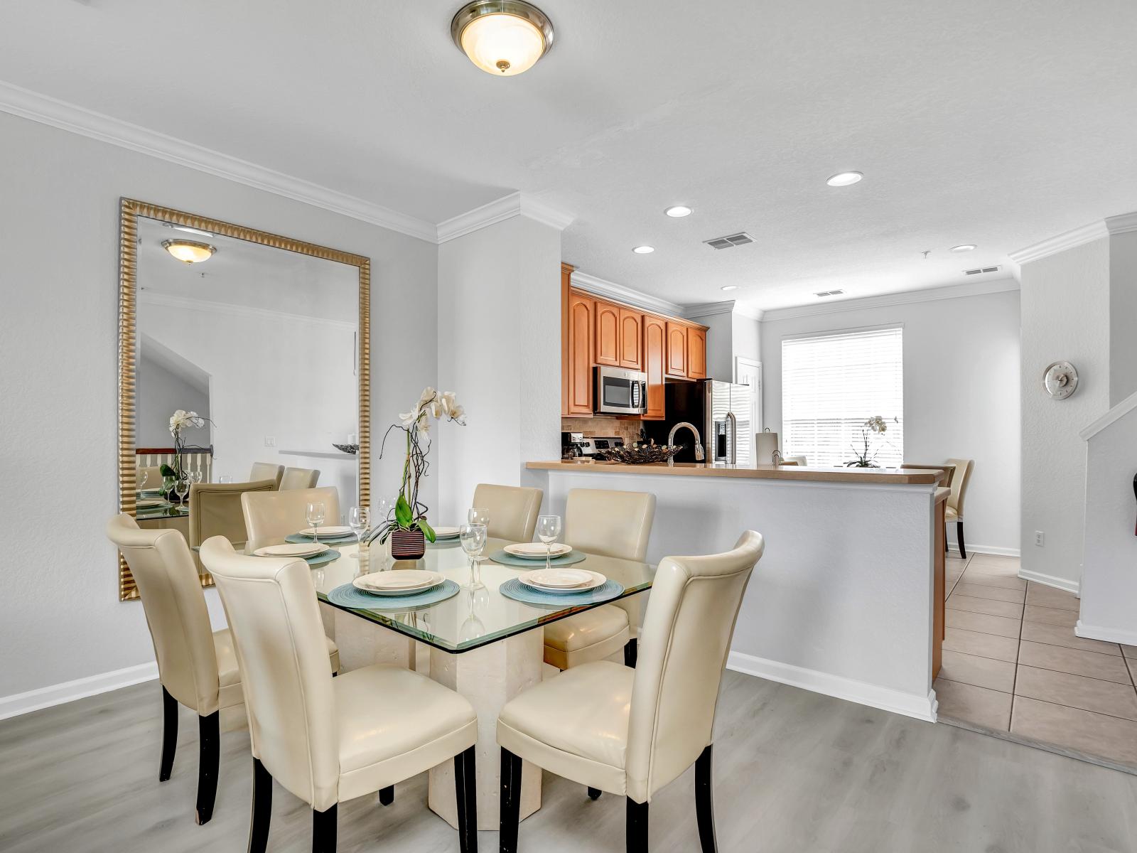 Gather around this cozy dining table for four, perfect for enjoying meals together in the comfort of your townhouse retreat.