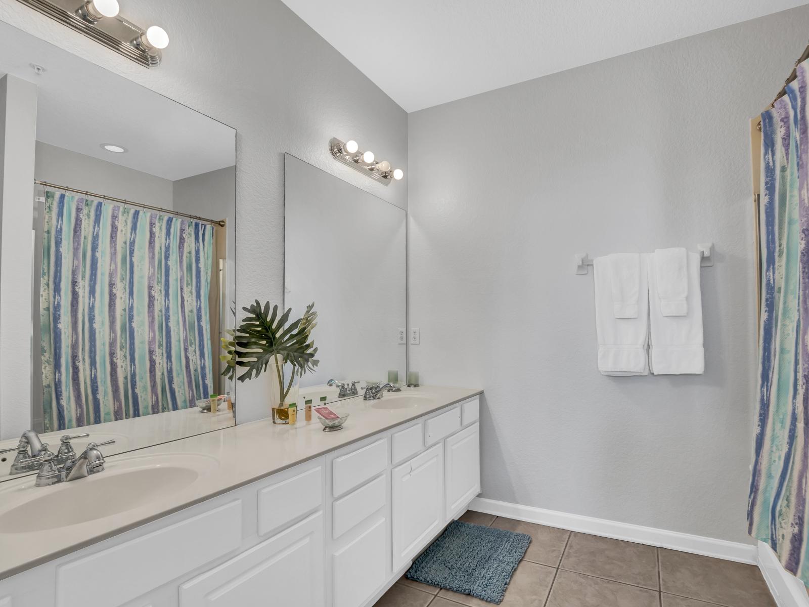 Step into the master bedroom's ensuite bathroom where you'll find two vanity mirrors and a spacious shower for a rejuvenating experience.