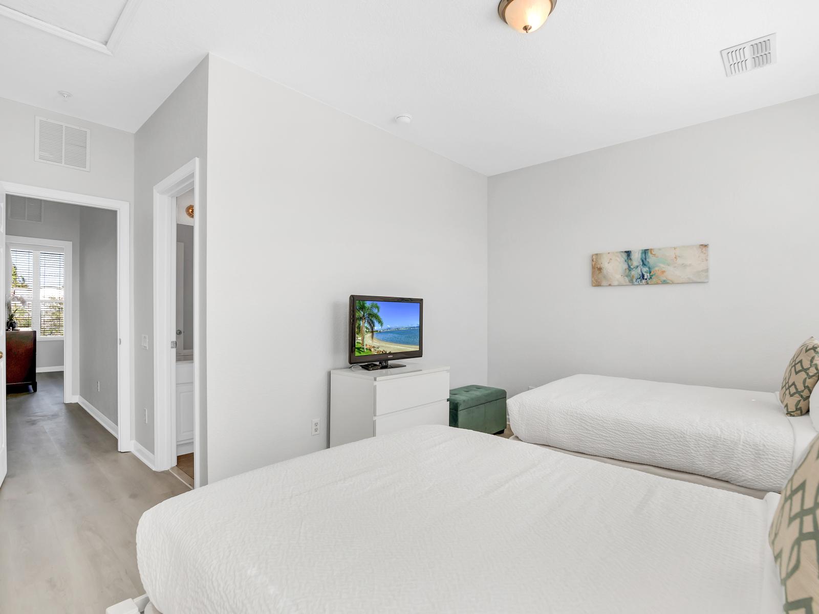 Relax and unwind in our inviting bedroom with two beds. Perfect for families or friends traveling together, this cozy space offers double the comfort for a restful night's sleep.