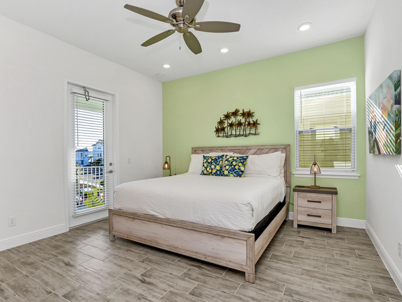 - Calming bedroom of the cottage in Florida - Experience tranquility in adorned with a soothing pastel green accent wall - Embrace serenity and unwind in this peaceful oasis - Cozy retreat with a plush bed, perfect for relaxation