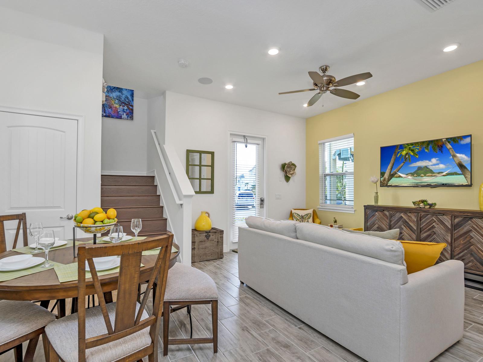 - Lush living and dining area of the cottage in Florida - Entertain in style with seamlessly integrated dining and living area - Enjoy the perfect balance of comfort and sophistication - Dine and unwind in this inviting space