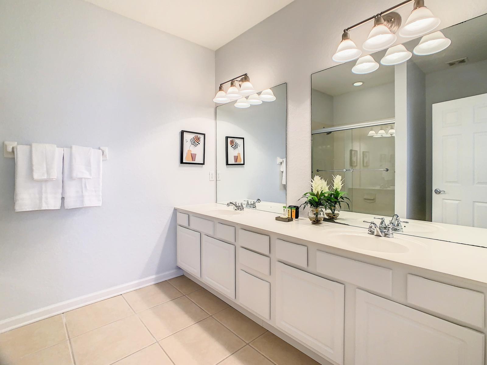 The Main bathroom  features a double sink and a convenient tub/shower combination, offering the perfect blend of style and functionality for your ultimate comfort.