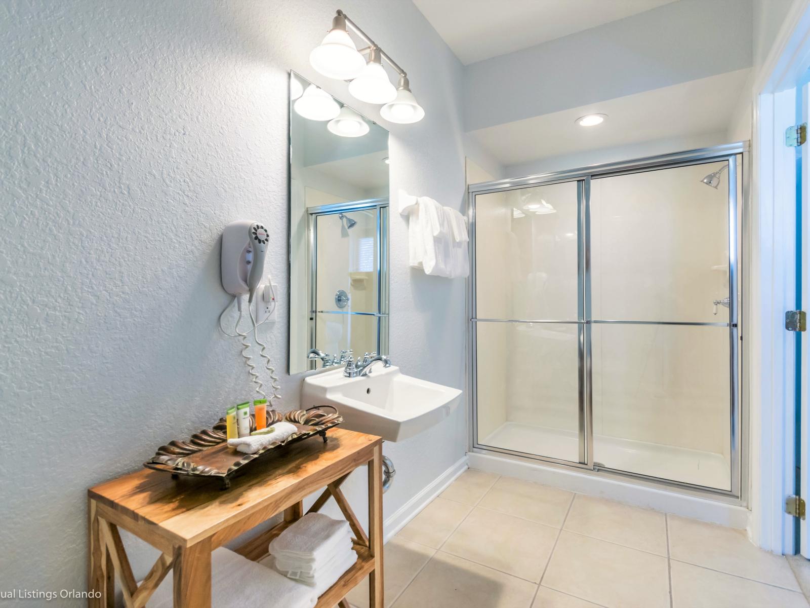 Step into our sleek bathroom featuring a stylish shower enclosure. With its contemporary design and functional layout, it promises a refreshing start to your day, every day.