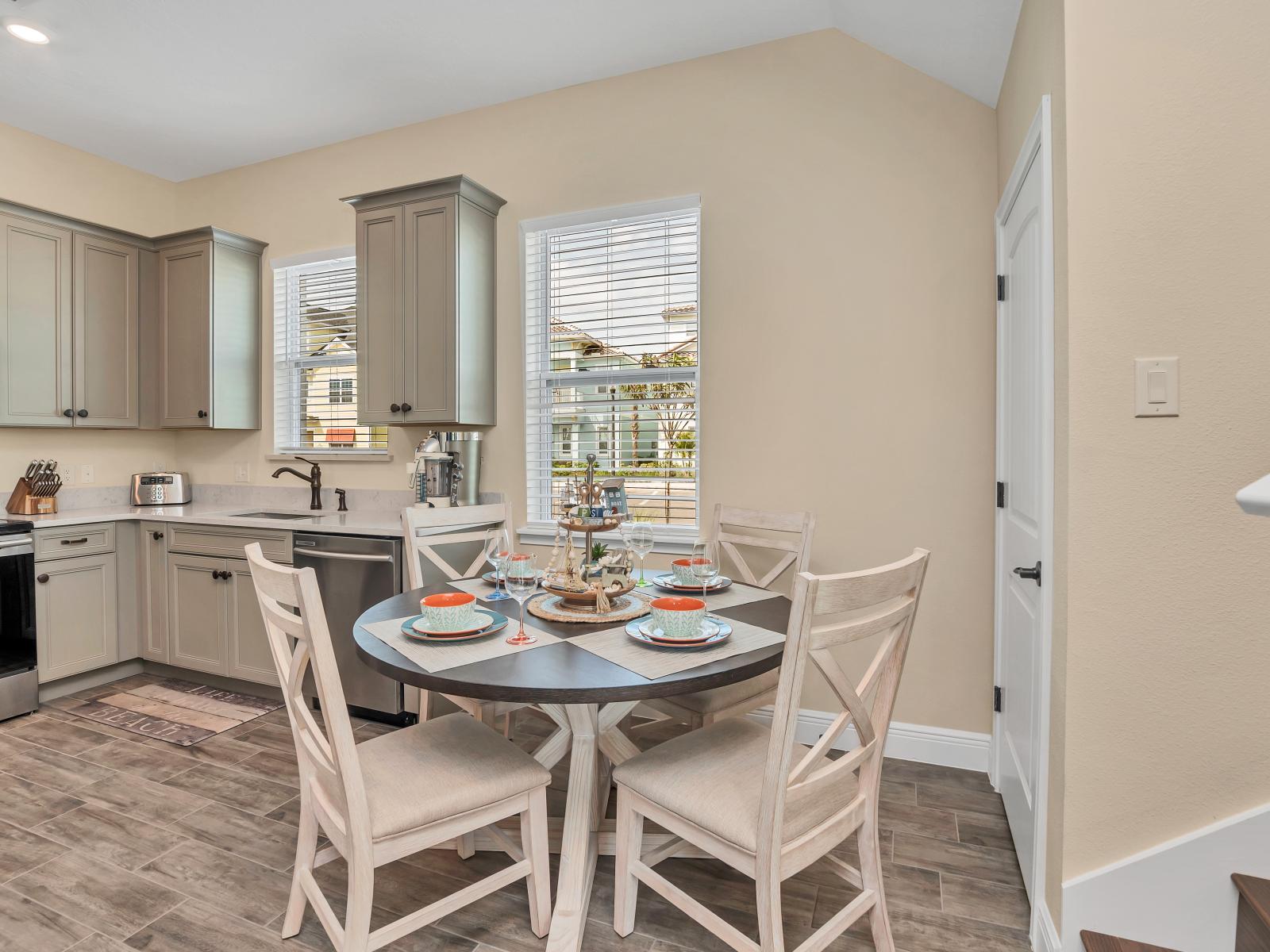 Discover the sleek kitchen and dining area of our Florida cottage, where modern style meets comfort and convenience.