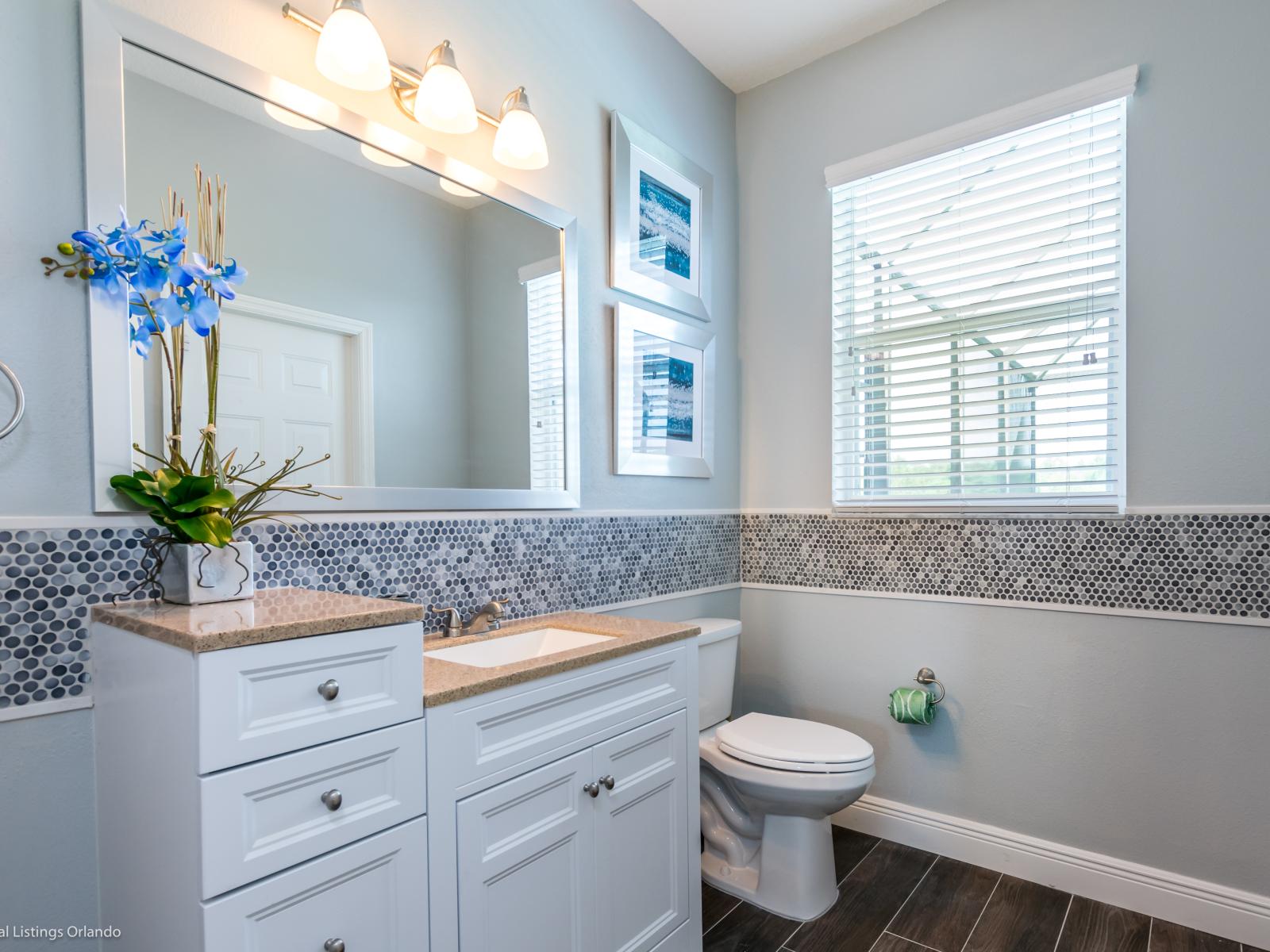 High-end Bathroom of the apartment in Orlando - Beautiful Vanity with large size wall mirror - Sufficient storage space - Neat and clean toilet seat - Availability of all bathroom amenities - Stunning glass cabin shower area - Neat and cosy Bathtub