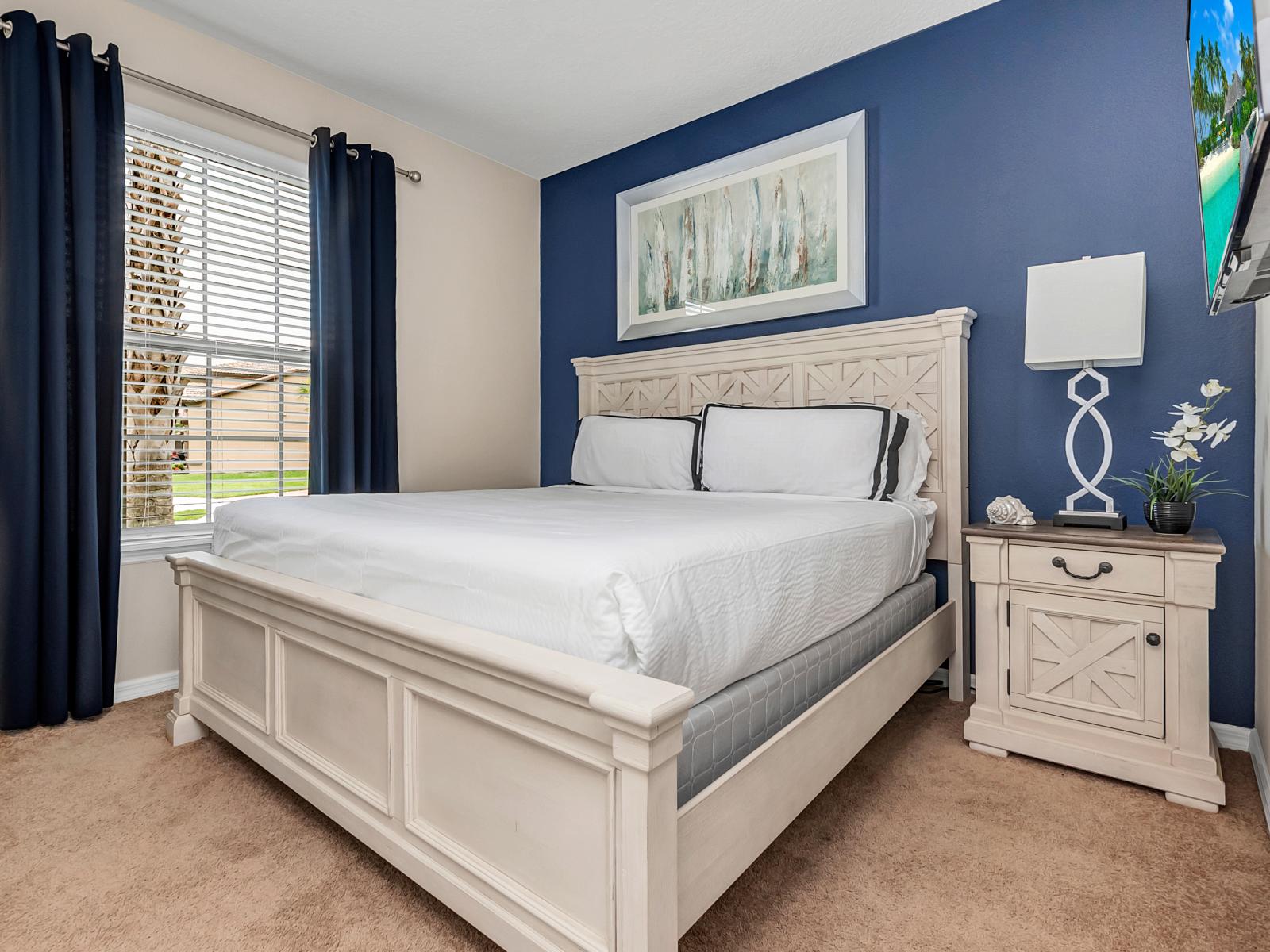 Blue Serenity: This bedroom's striking blue accent wall brings a sense of calm and serenity, offering a tranquil retreat where relaxation meets style in perfect harmony.