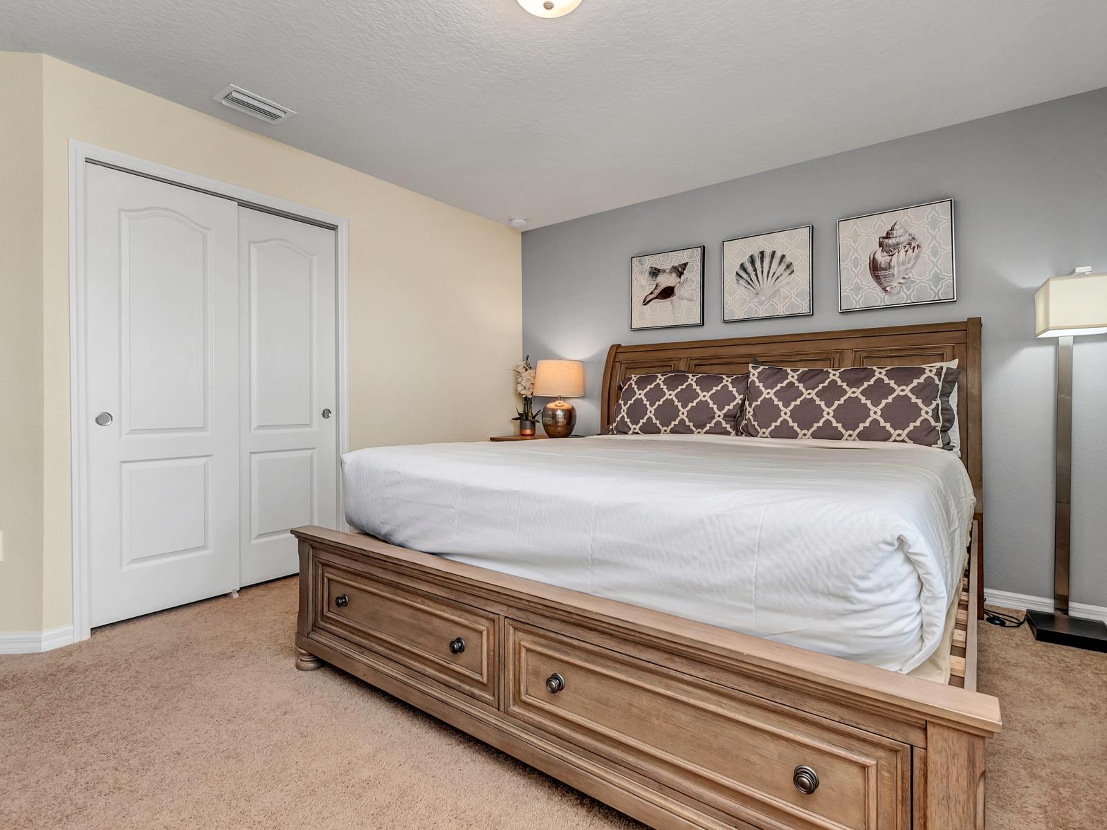 The bedroom, adorned with white details, radiates a timeless tranquility, offering a serene retreat where simplicity meets sophistication, creating a space of peaceful rejuvenation.