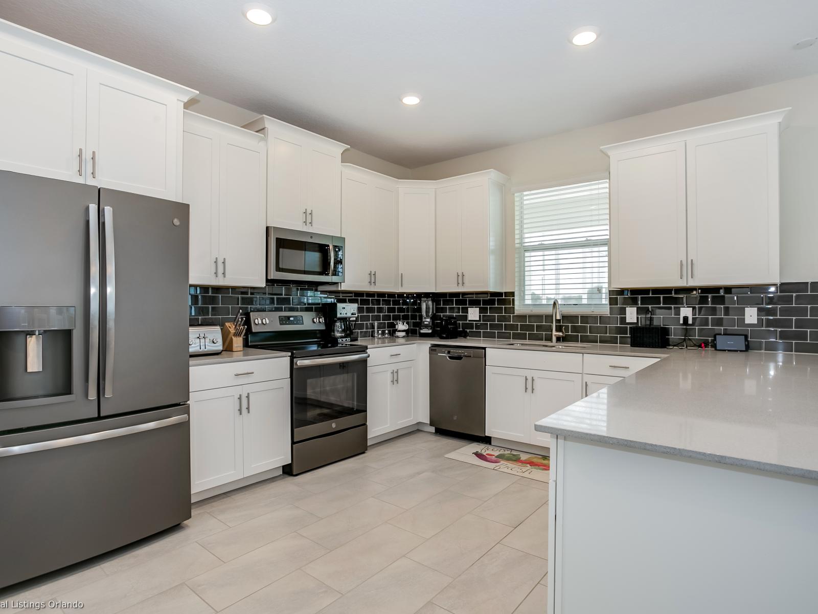 - Modern Kitchen of the Home in Florida - Sleek stainless steel appliances - Contemporary design with clean lines and minimalist aesthetics - Smart use of space with versatile storage solutions