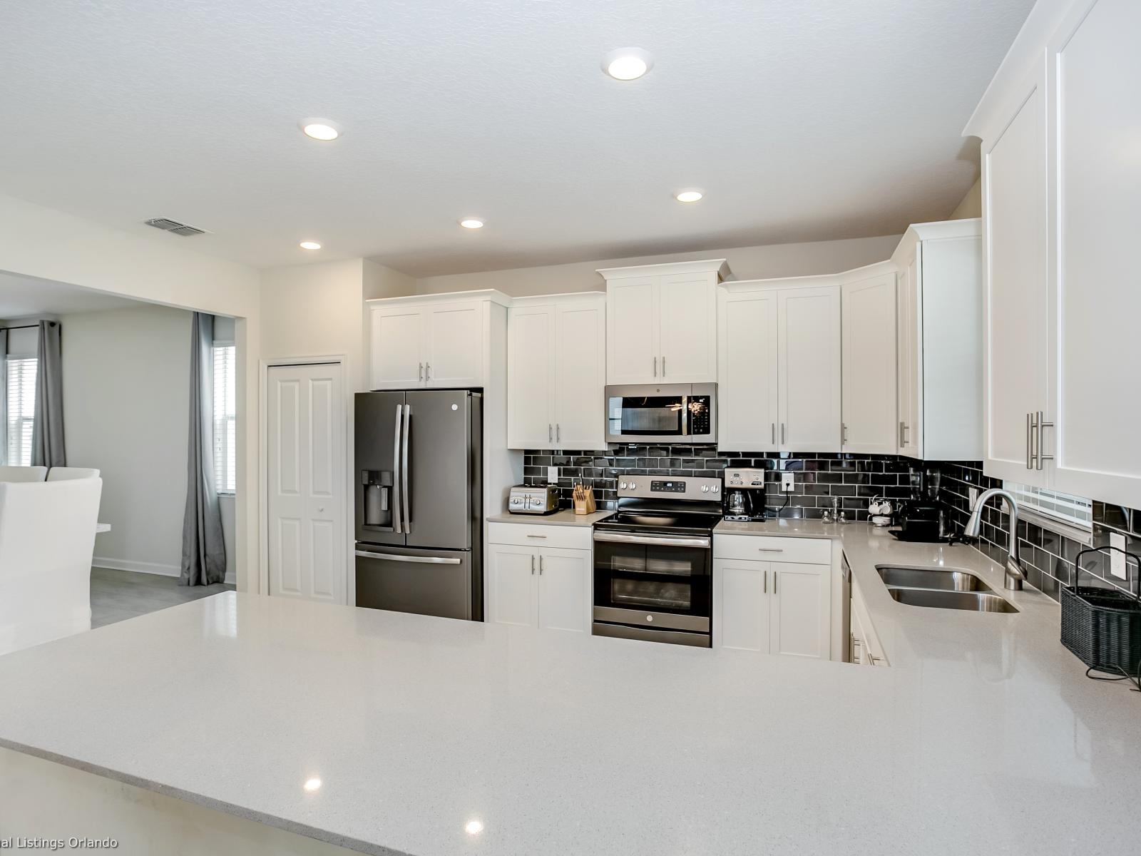 - Sleek Kitchen of the Home in Florida - This Kitchen blends style with functionality - Offering a refined space to unleash culinary creativity -  Sleek stainless steel appliances