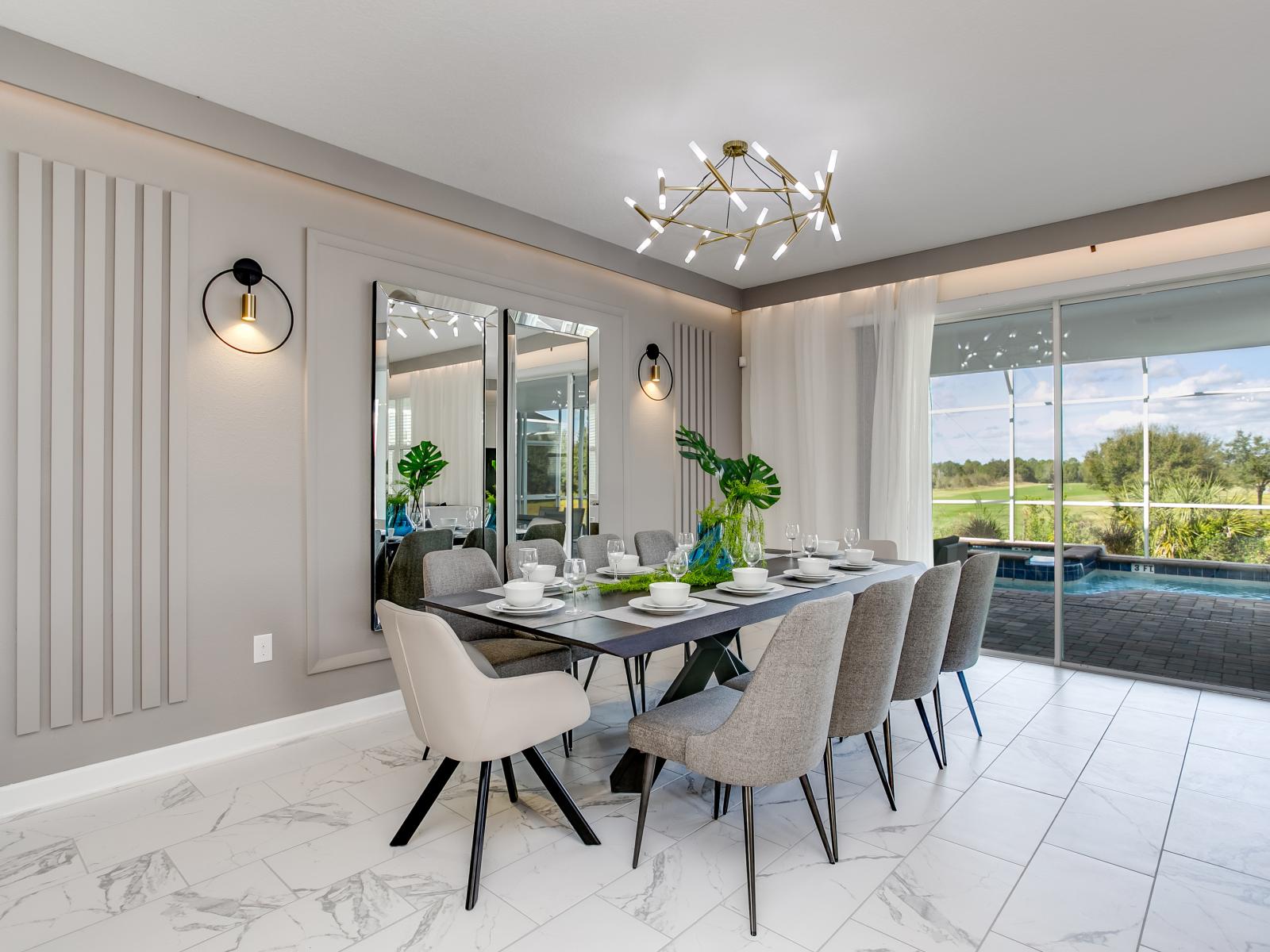 Dining area adjacent to the living space, facing the kitchen, offering views of the outdoor pool.