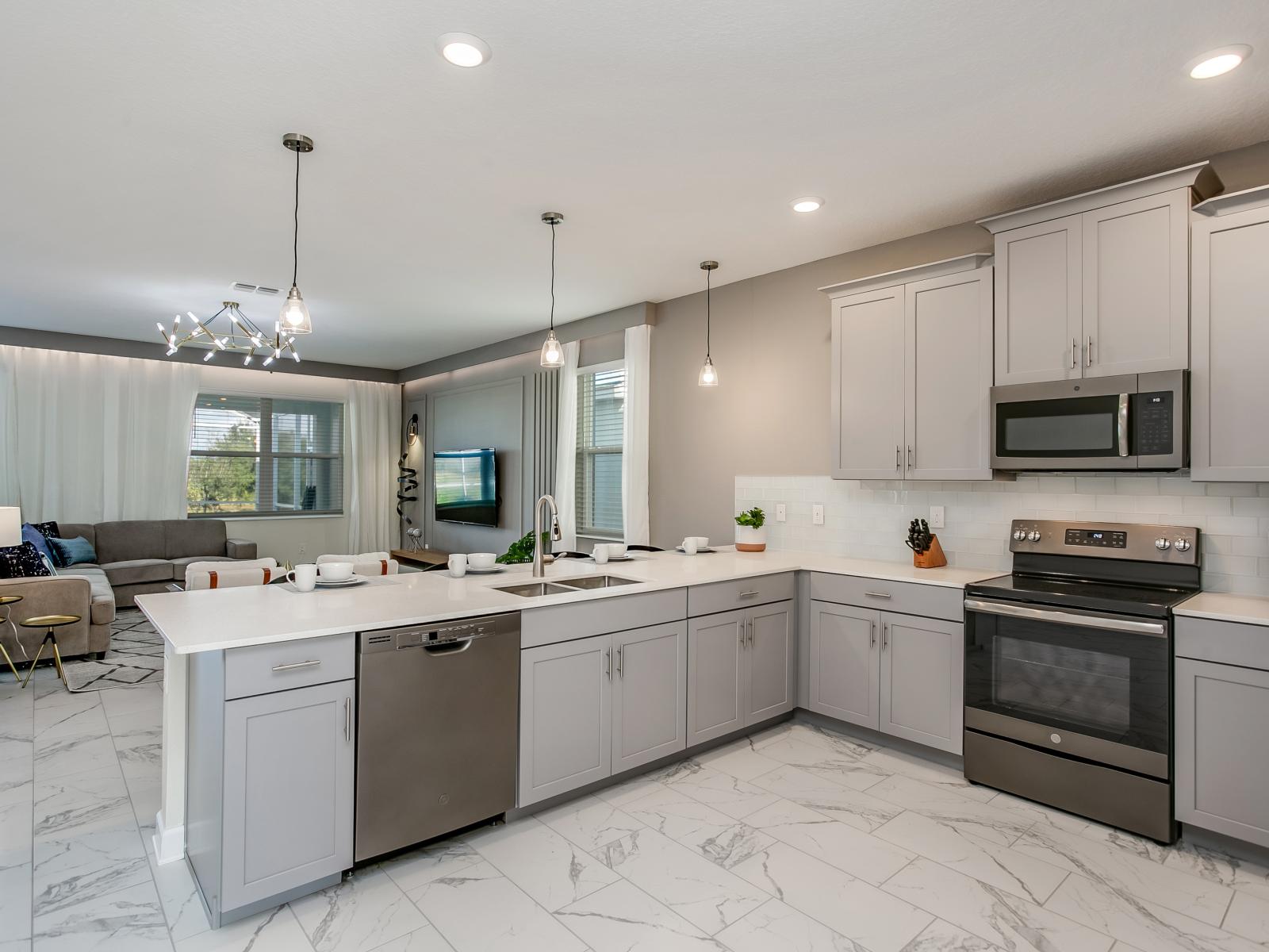 Experience a modern open concept design that exceeds all your needs. This versatile area is perfect for brewing coffee, preparing favorite meals and snacks, or storing food in the spacious fridge.