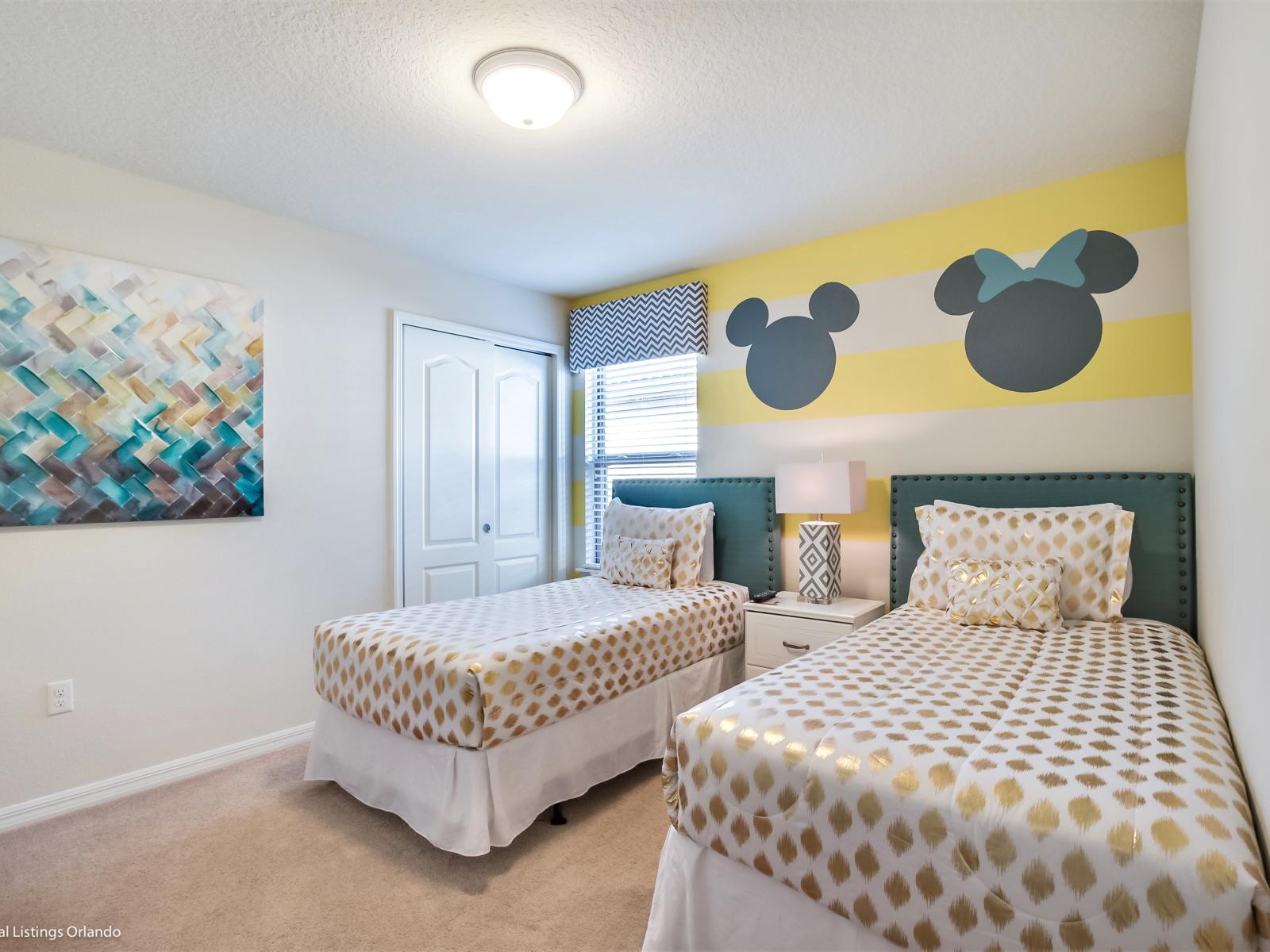 A bedroom where the magic of Disney fills the space. With two beds adorned with iconic Mickey motifs, it's a whimsical retreat where dreams come alive and imaginations soar.