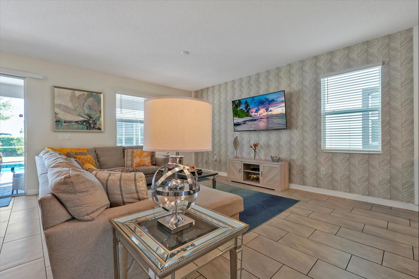 Living room with large sectional and large flat screen tv