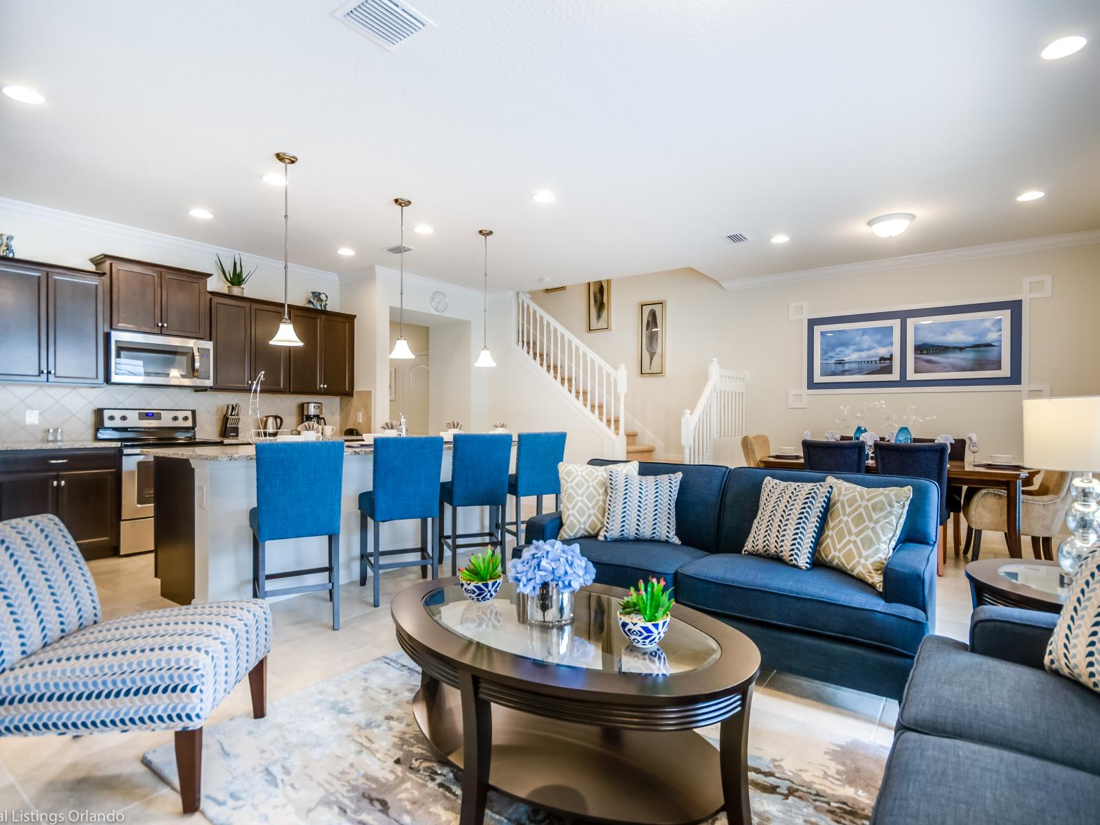 The living area and kitchen area blend seamlessly, creating a harmonious space where relaxation meets culinary creativity. A hub of activity and comfort, promising shared moments and cherished memories in every corner.