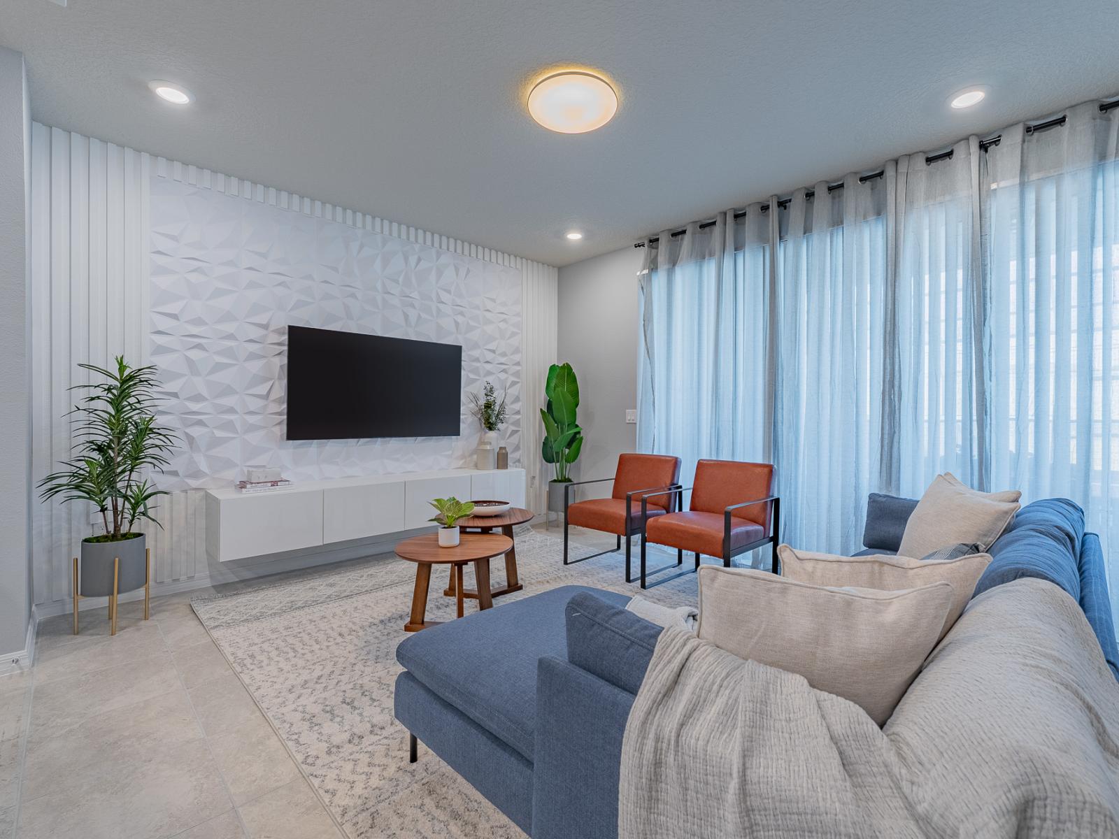 Airy living haven of the home in Davenport, Florida - Enhanced with white accents for a sense of comfort and spacious feel - Equipped with a Smart TV for endless Netflix entertainment - Elegant furniture arrangement ensuring utmost comfort